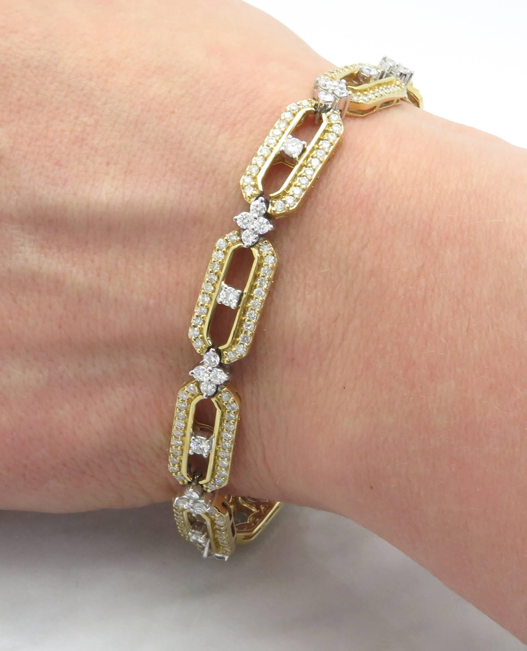 This beautiful bracelet features 268 Round Brilliant Cut Diamonds set into 14k Yellow Gold. The Bracelet features a unique design of links and star-bursts. The diamonds have H-K color and I clarity. The total diamond weight is approximately 4.00CTW.