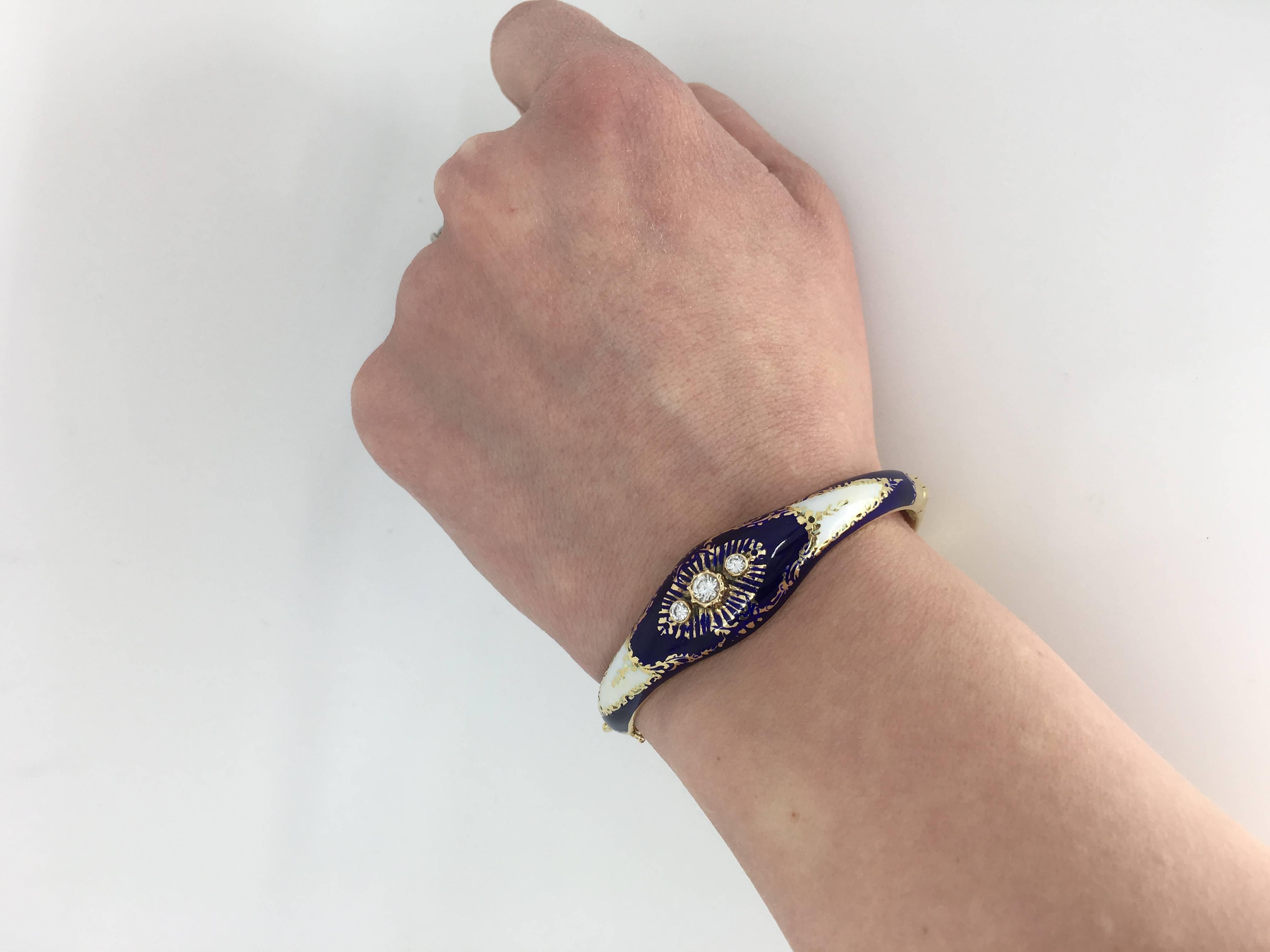 This intricate 14K gold and enamel bracelet features hand crafted blue and white enamel in addition to three Round Brilliant Cut Diamonds. The total diamond weight is approximately .36CTW. The bracelet weighs 30.0 grams, and is a 6