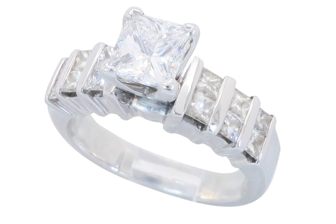 This gorgeous ring features a EGL USA Certified .70CT Princess Cut Diamond in the center. The diamond is certified to have D color and VS2 clarity according to EGL USA. It is accented by 12 Princess Cut Diamonds. The total diamond weight is