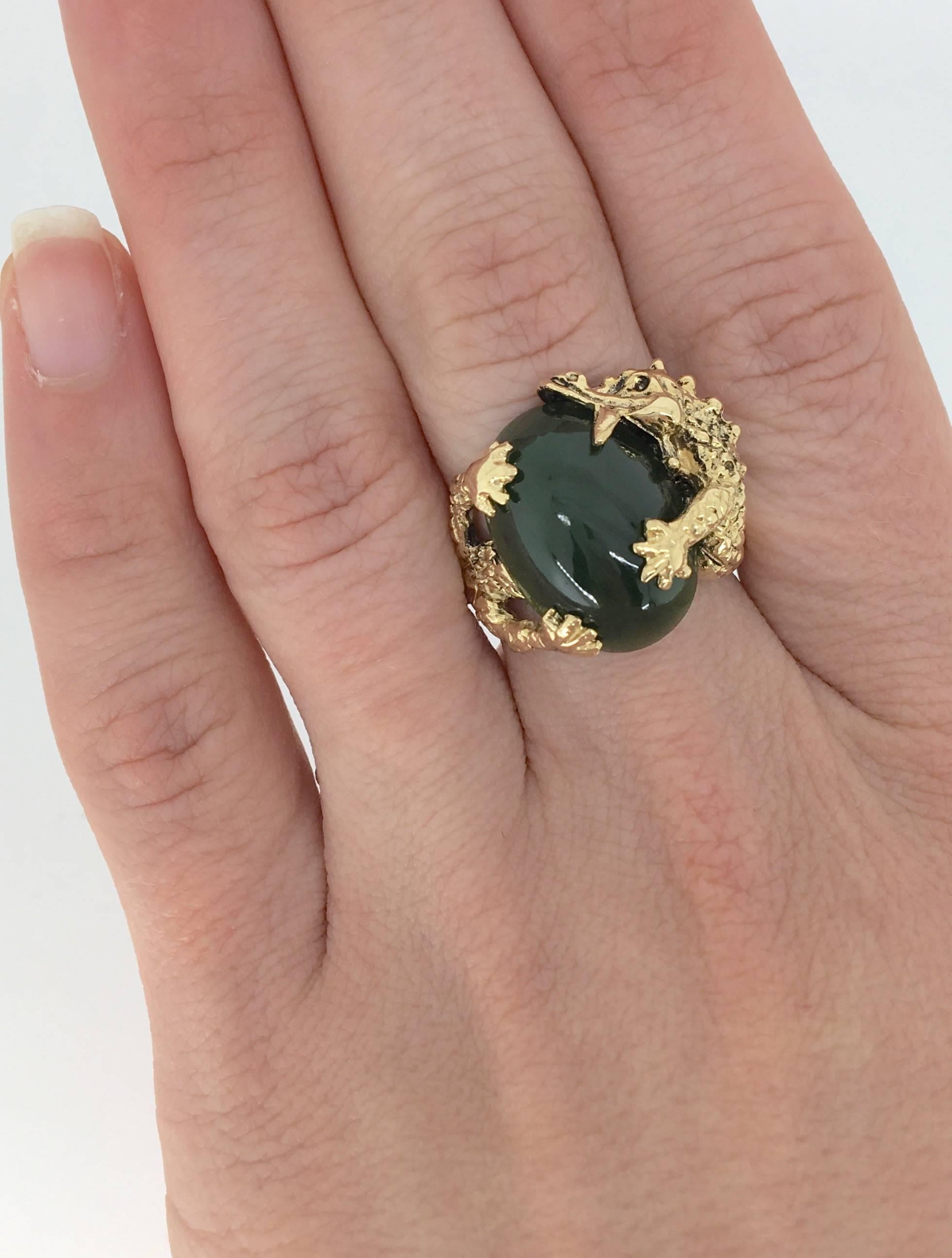 This unique ring features a large 18.0MM X 12.8MM Jade. The ring is crafted to resemble a dragon wrapped around the jade. The 14K yellow gold ring is size 7.75 and weighs 11.6 grams.