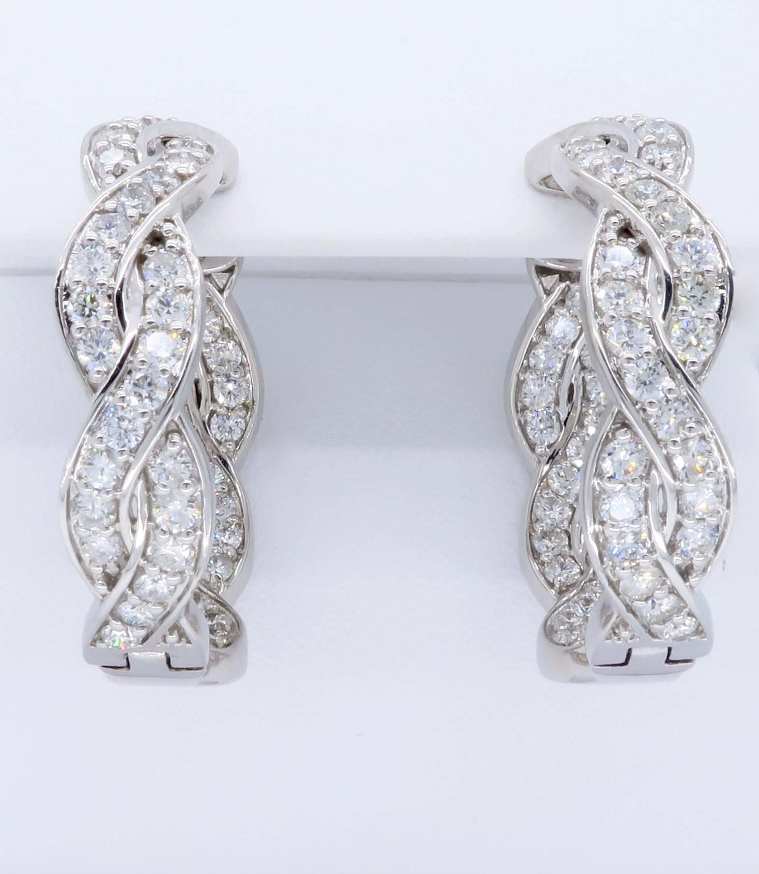 These sparkling inside out diamond hoop earrings feature 112 Round Brilliant Cut Diamonds. The diamonds have F-H color and I-SI clarity. The total diamond weight is approximately 3.18CTW. The 14K white gold earrings weigh 17.3 grams.