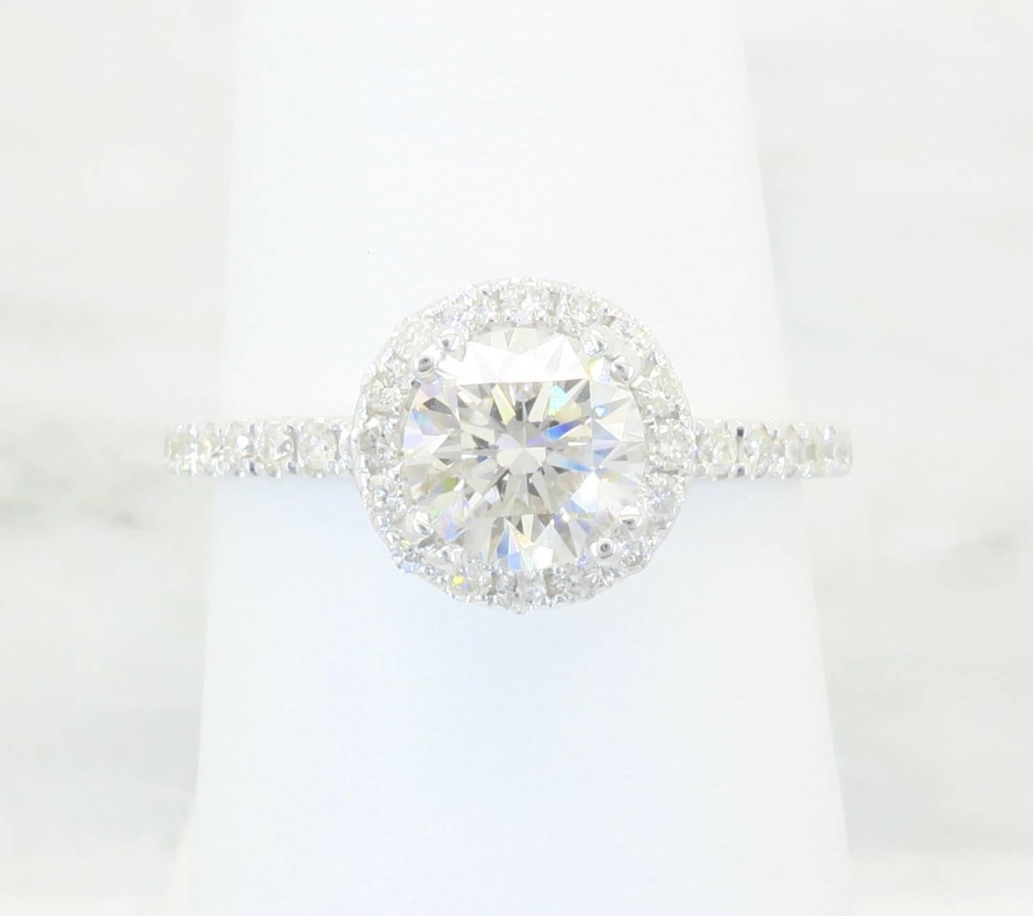 Very elegant 18K White Gold Odelia Designer Diamond ring with a .80CT Round Brilliant Cut Diamond. This diamond is H-I color and I1 Clarity. The ring also contains an additional 36 Round Brilliant Cut diamonds. The total carat weight is