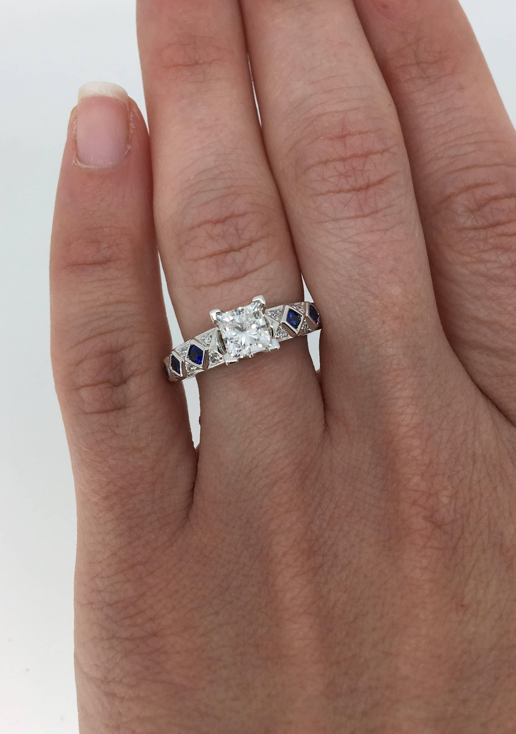 Engagement Ring from Renditions line of designer Harout R. The ring features an IGI certified 1.06CT princess cut diamond with G color, SI2 clarity. It is accented by 26 Round Brilliant Cut Diamonds and 6 blue sapphires. The total diamond weight is