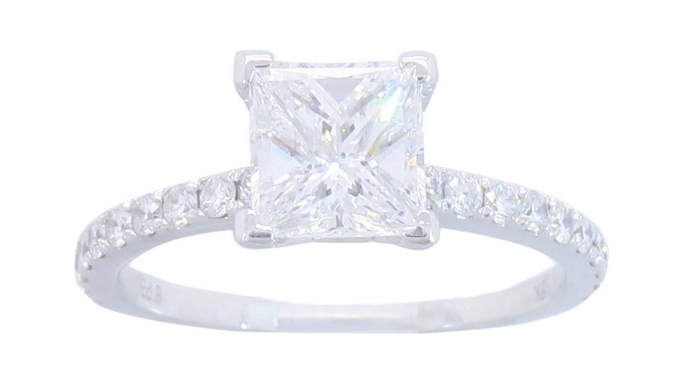 This simply elegant GIA Certified 18K White Gold Diamond ring features a gorgeous 1.01CT Princess Cut Diamond. The featured diamond has E color and is SI1 clarity, per the included GIA Certification. There is an additional 20 beautiful Round