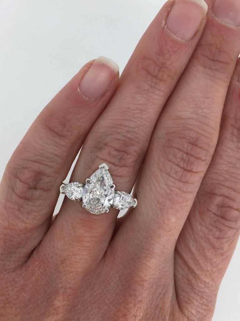 This stunning Sabet engagement ring features a large GIA Certified 2.07CT Pear Cut Diamond. The diamond has an impressive E color and VS1 clarity. It is accented by two more Pear Cut Diamonds and 16 Round Brilliant Cut Diamonds. The total diamond