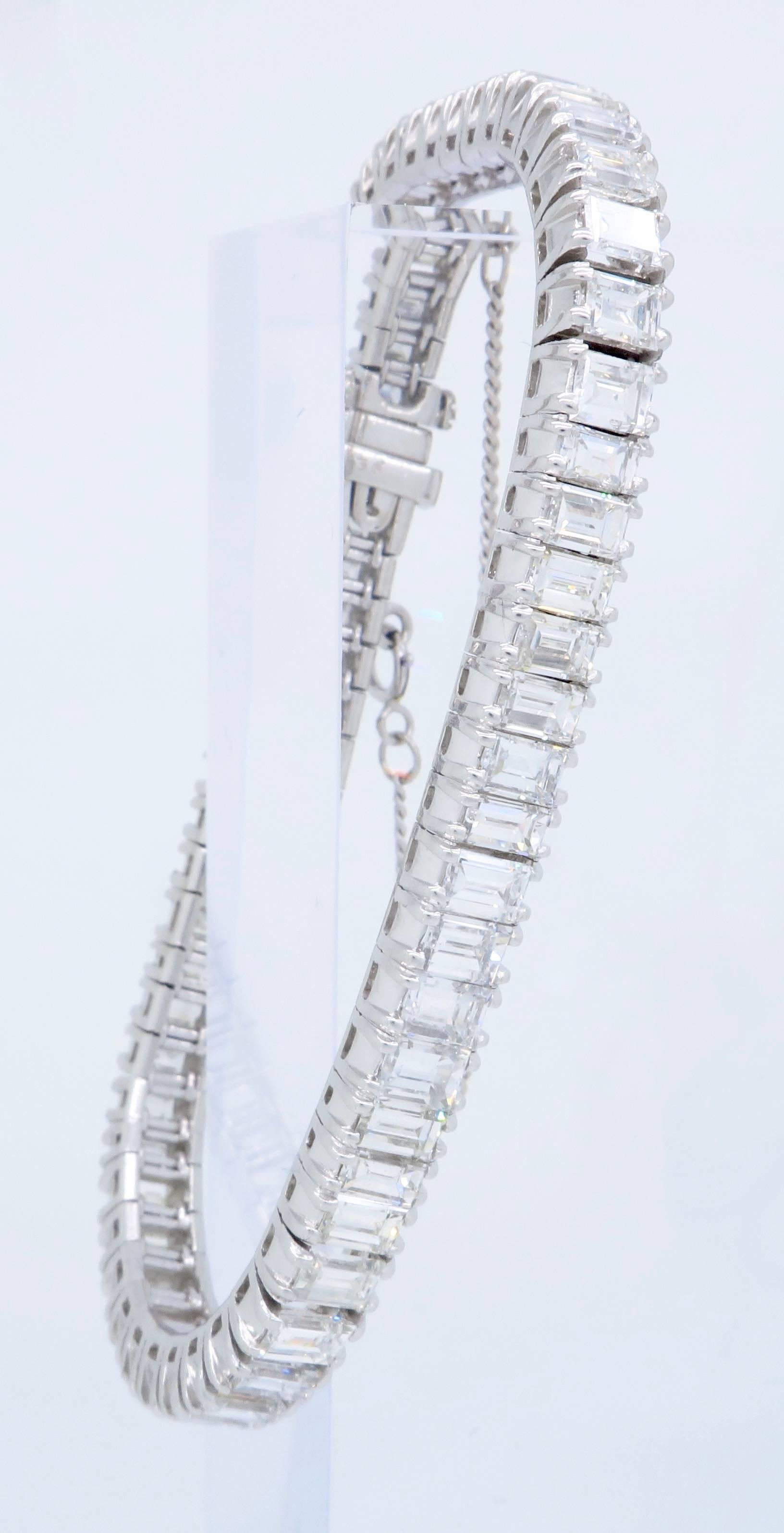 This absolutely stunning platinum tennis bracelet features 60 Emerald Cut Diamonds. Most of these gorgeous diamonds displays F-H color and VS1-SI1 clarity, a few diamonds display I-K color and SI2-I1 clarity. There is approximately 12.16CTW of