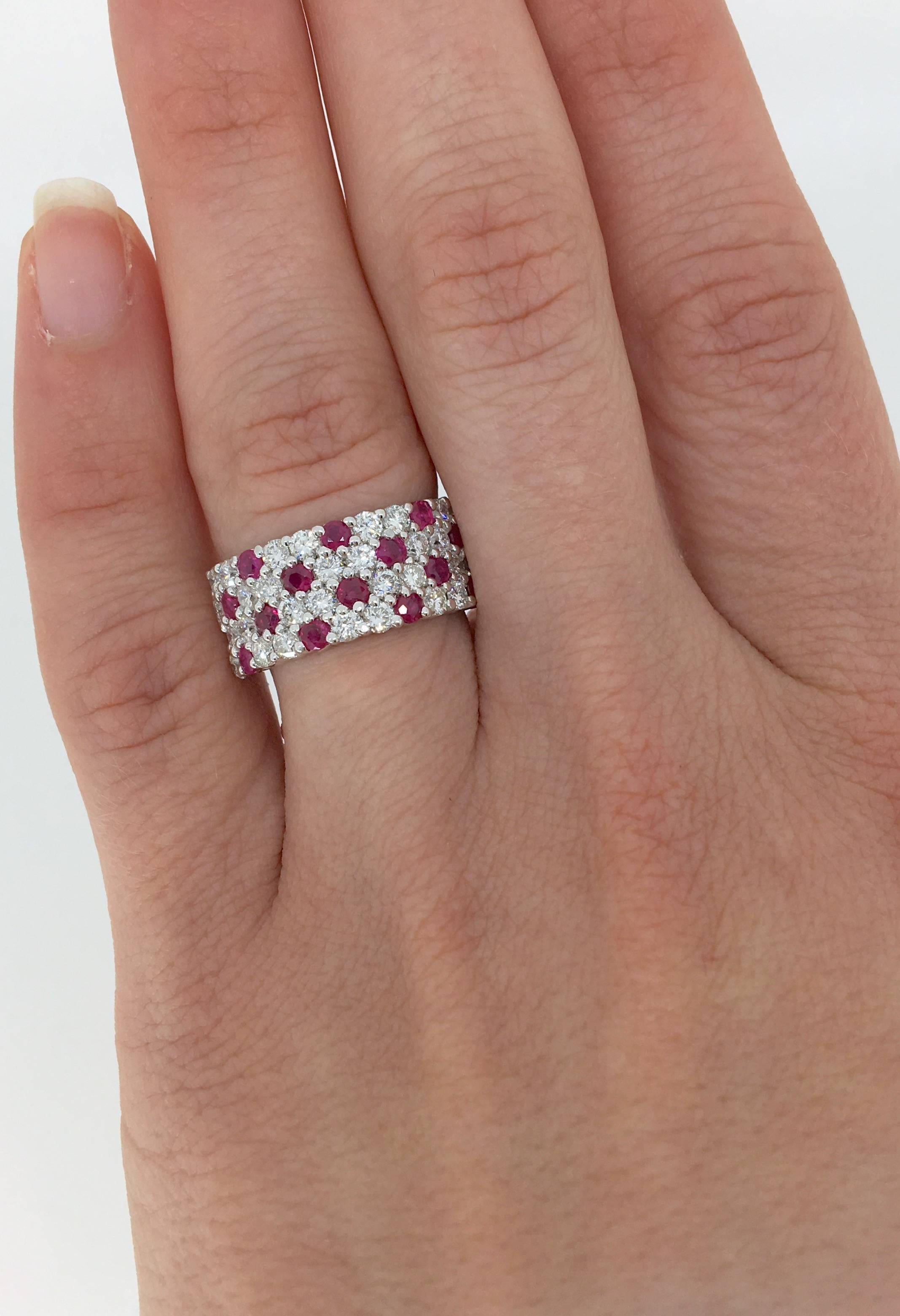 14K white gold ring features 32 Round Brilliant Cut Diamonds and 14 Round Rubies evenly spaced across the band. The gorgeous ring houses approximately 1.60CTW of diamonds. The ring is currently a size 6.5 and weighs 6.2 grams.