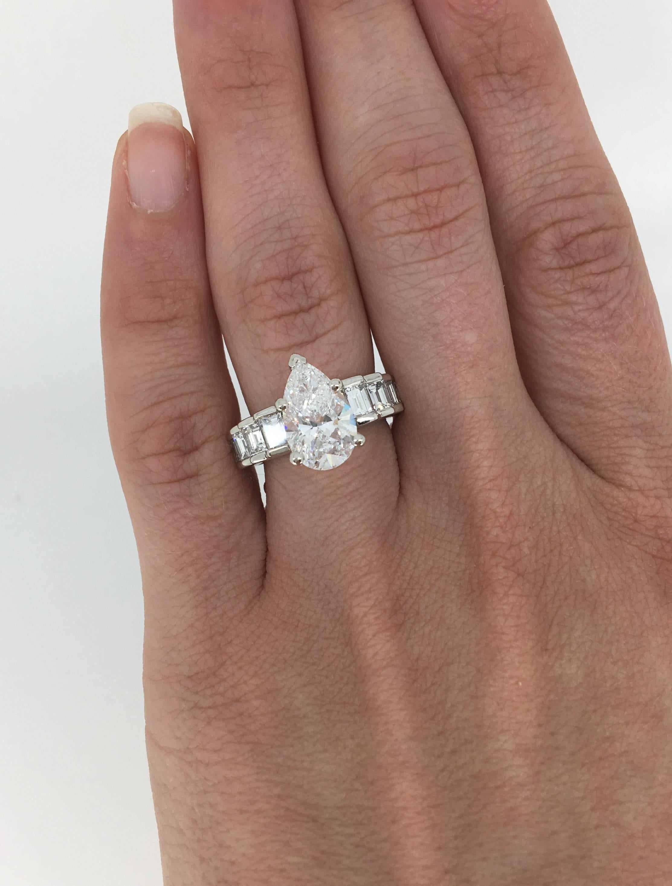 Approximately 2.62 CT Pear Cut Diamond with D-E color, SI2 clarity set in Platinum with 8 Emerald Cut diamonds accenting. There is approximately 3.90CTW of diamonds. The platinum ring weighs 11.4 grams and is currently a size 5.75. 