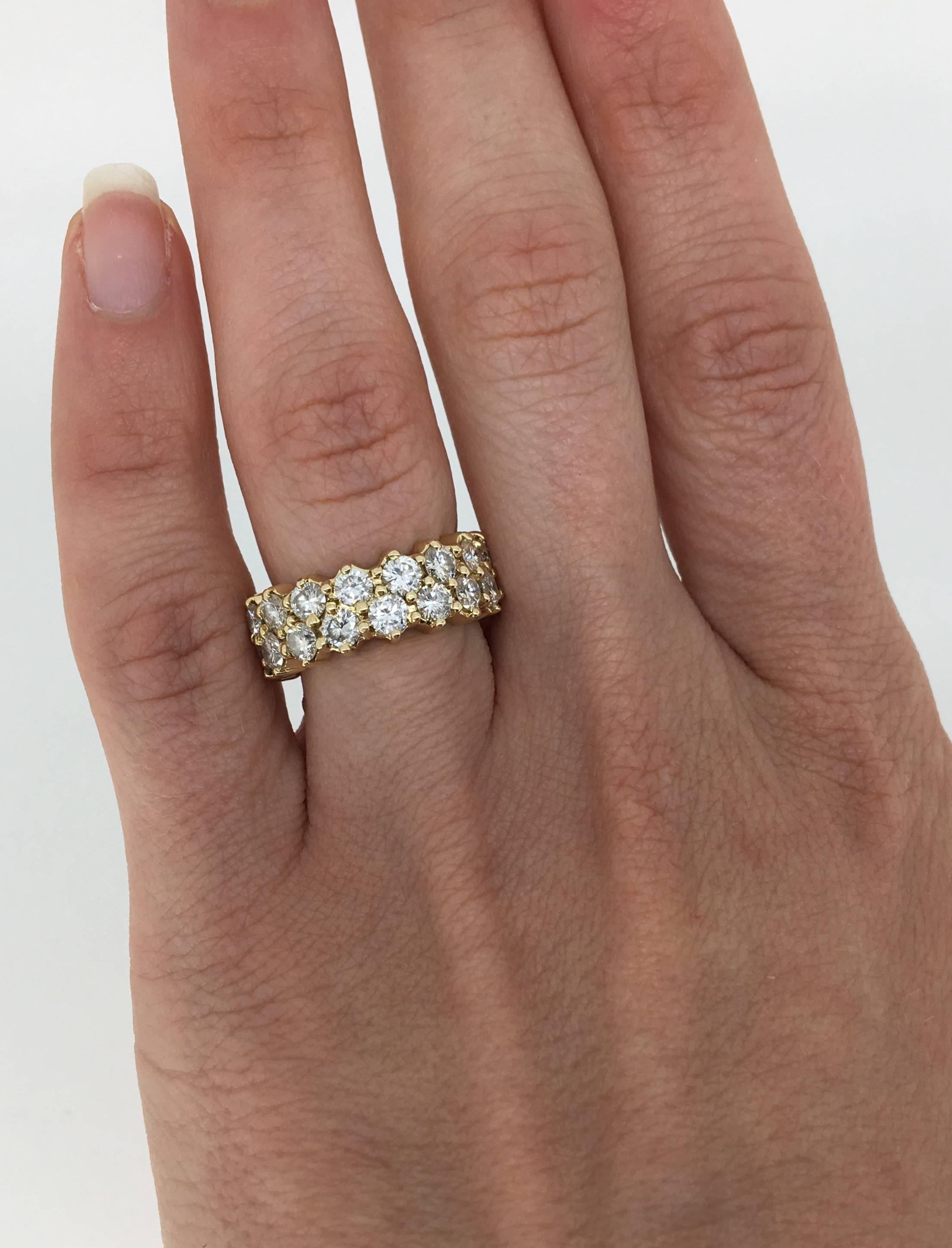 Eternity style diamond ring has two elegant rows of 34 Round Brilliant Cut Diamonds with a total carat weight of approximately 4.50ctw. The diamonds  display an average F-H color and average SI1-SI2 clarity. The 14K yellow gold ring is a size 5 and
