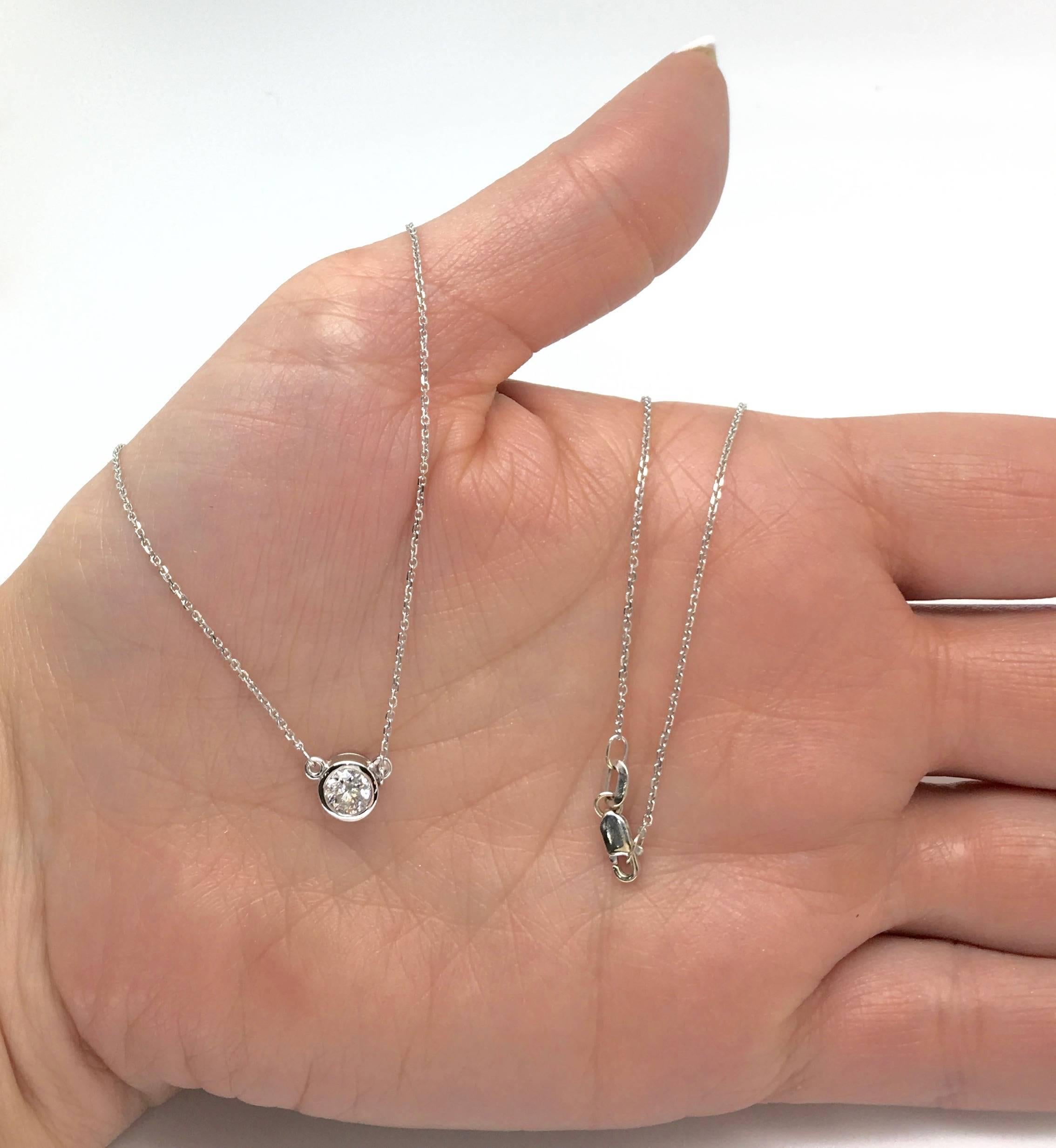 This 14K white gold necklace features an approximately .50CT Bezel Set Round Brilliant Cut Diamond. The diamond displays G-H color and I1 clarity. The necklace is 19” in length and weighs 2.6 grams.