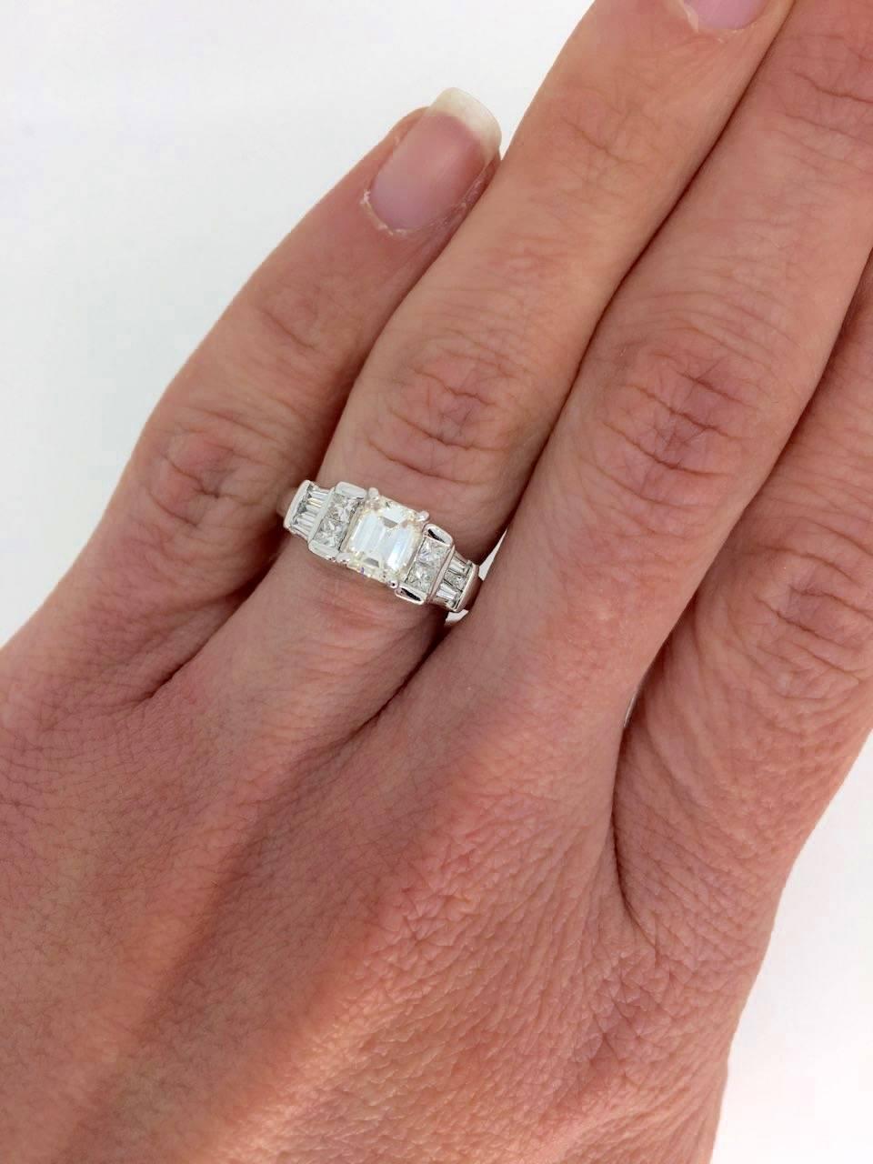 Emerald Cut diamond engagement ring set in 14K white gold.

Center Diamond Carat Weight: Approximately .65CT
Center Diamond Cut: Emerald
Center Diamond Color: J
Center Diamond Clarity:  VS2
Total Diamond Carat Weight: Approximately 1.07CTW
Accent