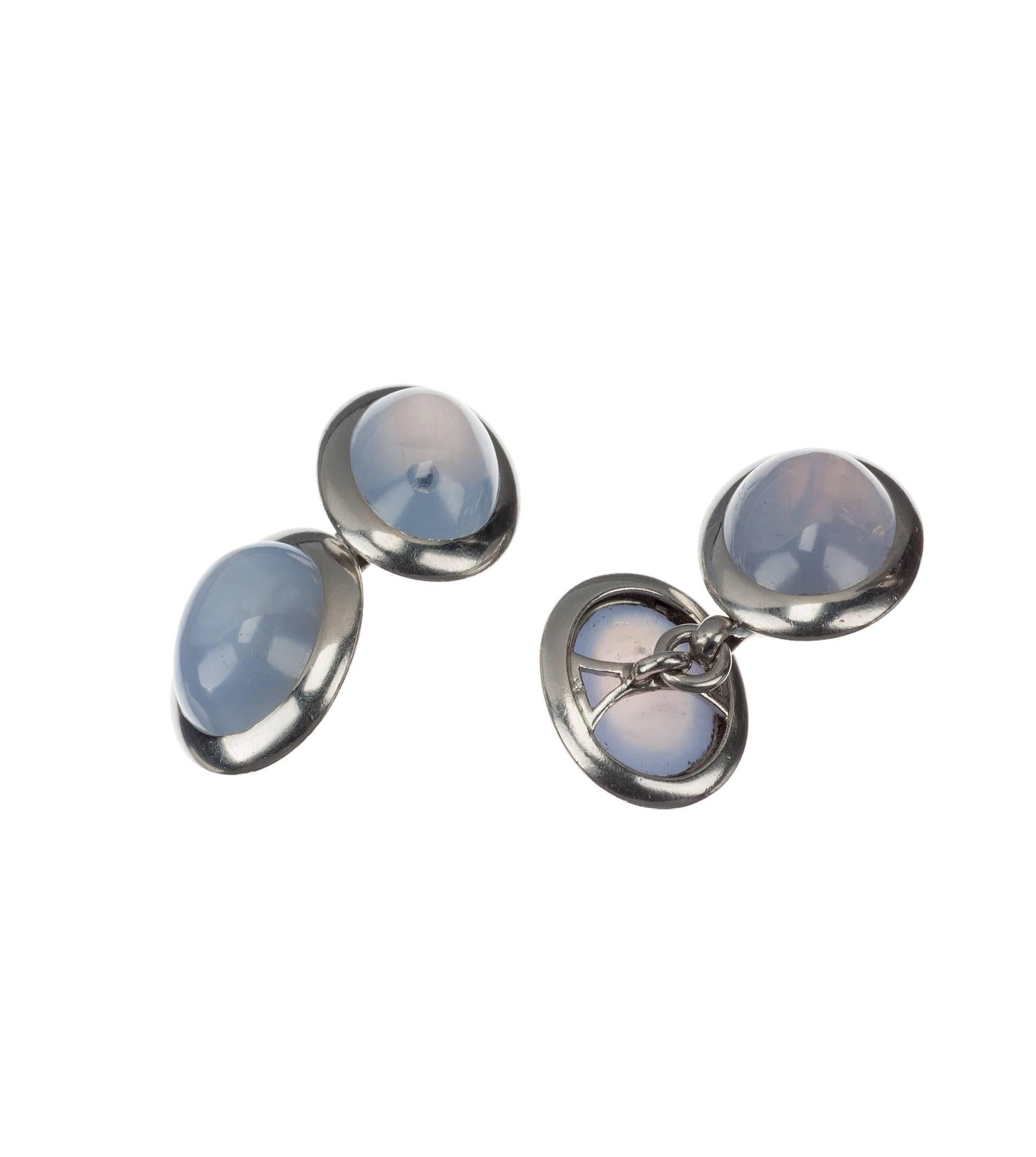 Four beautifully matched, natural oval star sapphires are set in platinum bezels, creating an understated, elegant pair of cuff links. 13mm x 15mm bezels.