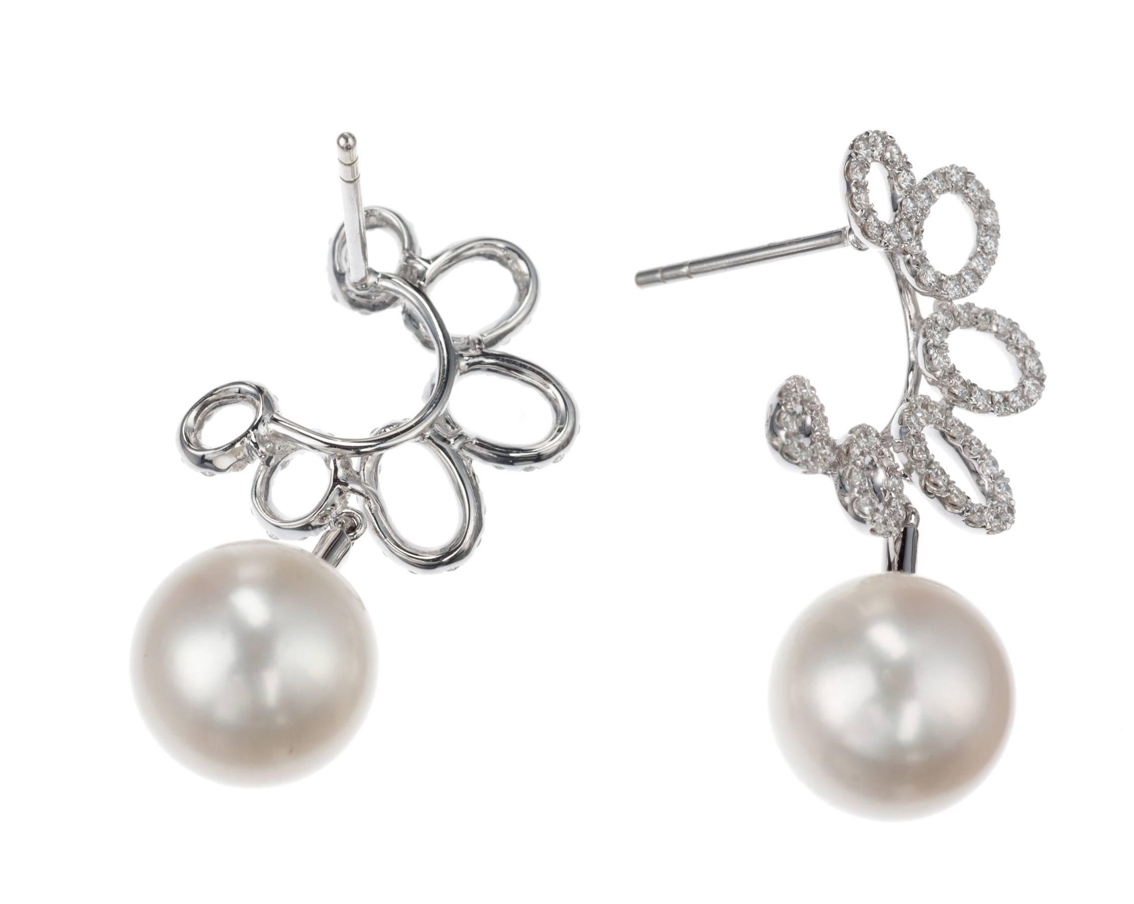 A pair of drop pearl earrings in 18-karat white gold from German designer Schoeffel. Its gentle crescents made from playful ovals lend these earrings a youthfulness and modern flair uncommon to pearls. The freshwater cultured pearls, 10-11mm, are