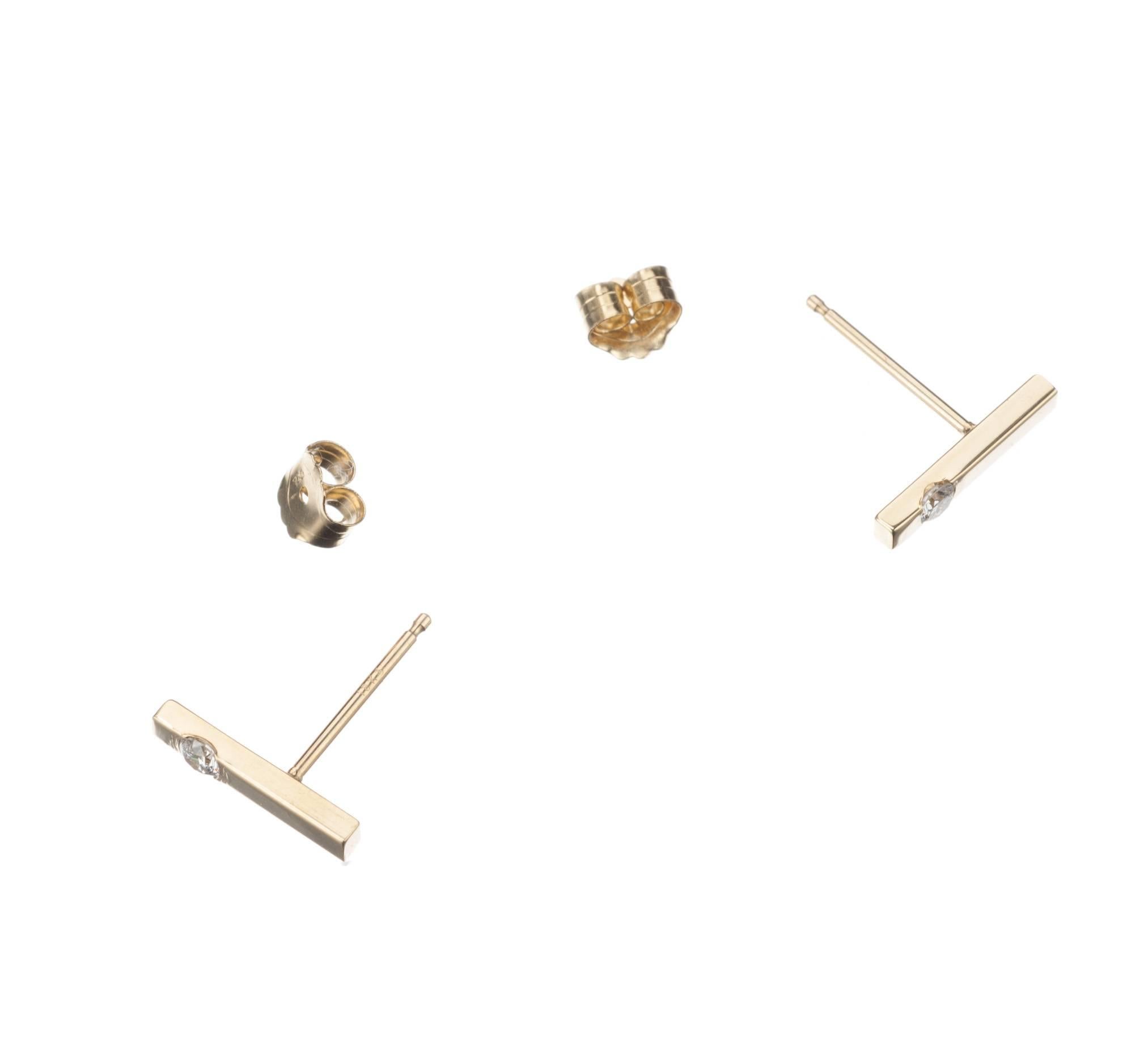 A pair of 18-karat yellow gold bar stud earrings from Elleard Heffern Fine Jewelers. A single brilliant-cut round diamond is set in each stud, .10ctw. of G-H color and SI1 clarity. Simple and eye-catching, these earrings are perfect for everyday