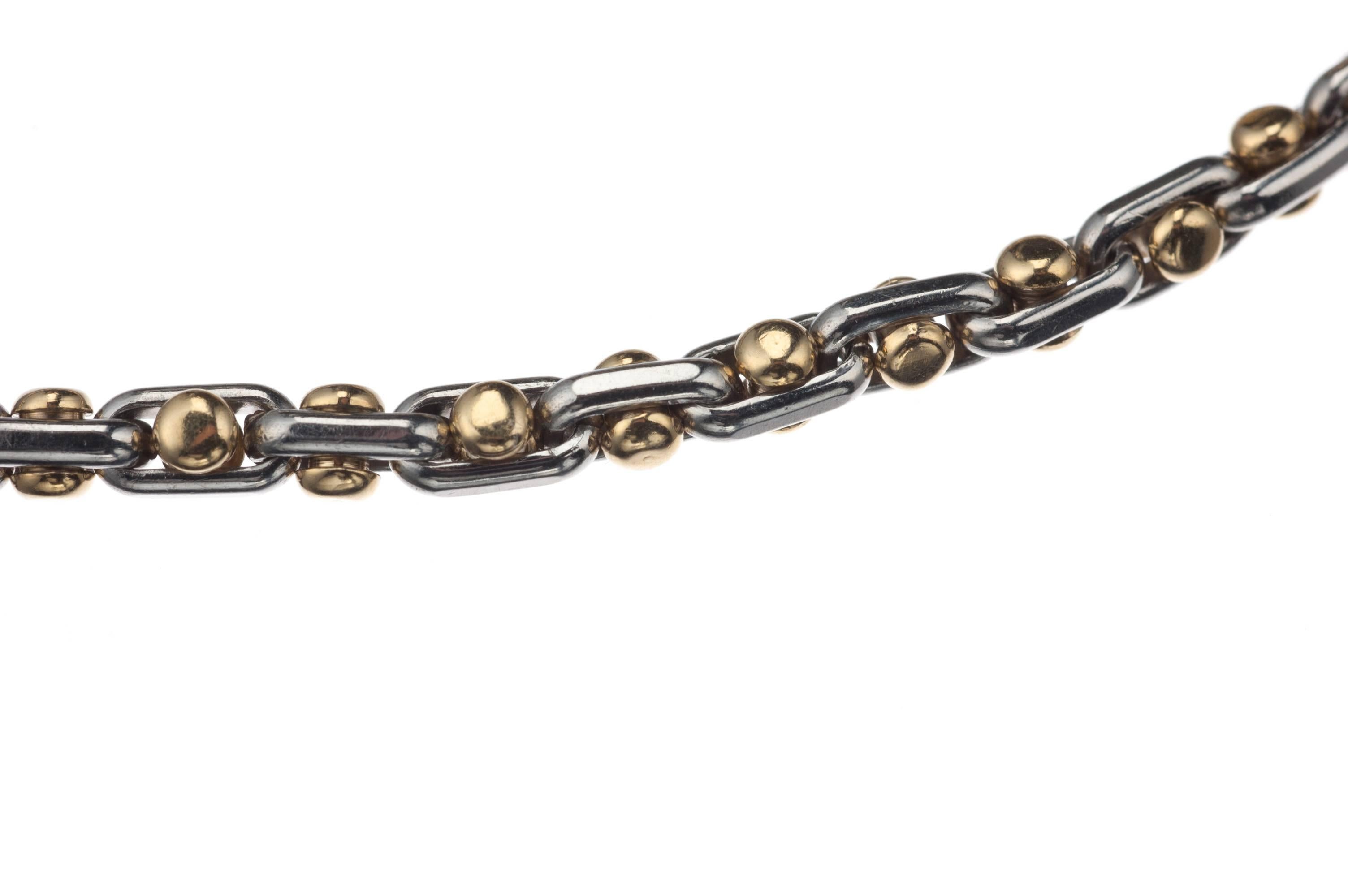 Fashioned in both platinum and 18-karat yellow gold, this distinct chain link bracelet has yellow gold bar bells inserted in the empty space of its platinum links giving the bracelet a unique texture and rhythm. Measures approx. 8.5” long. 
