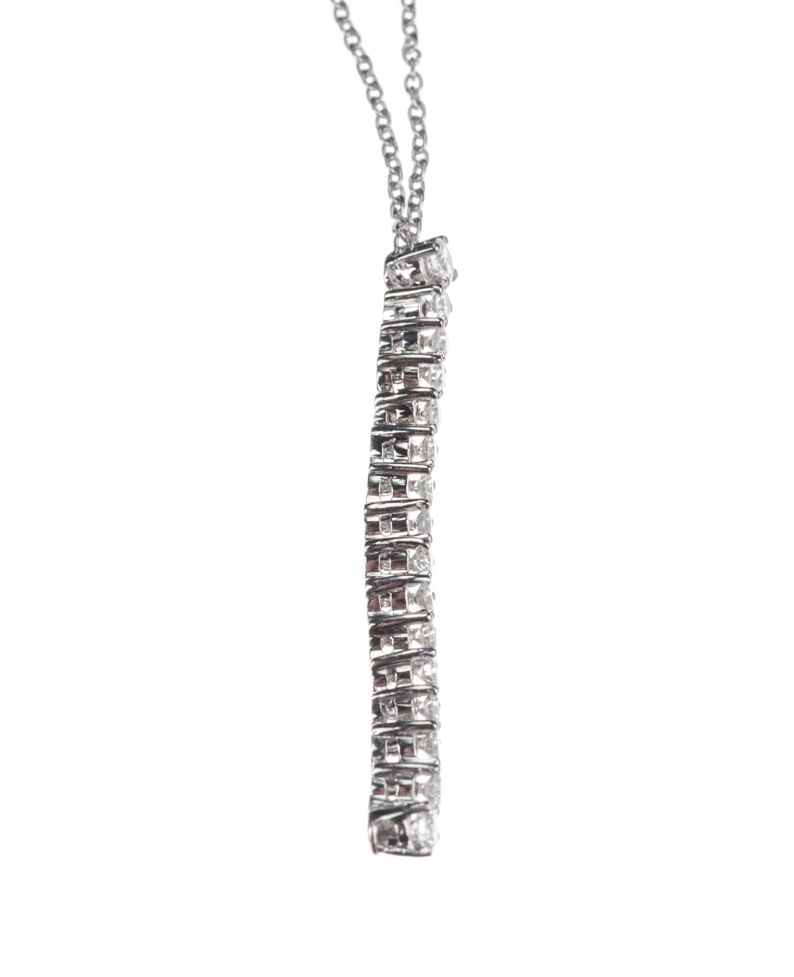 A sinuous, articulated strand of 16 brilliant-cut round diamonds, .64ctw., hangs from its platinum chain as a pendant. The line of diamonds measures approx. 1.5” long while the cable chain measures 16” long.