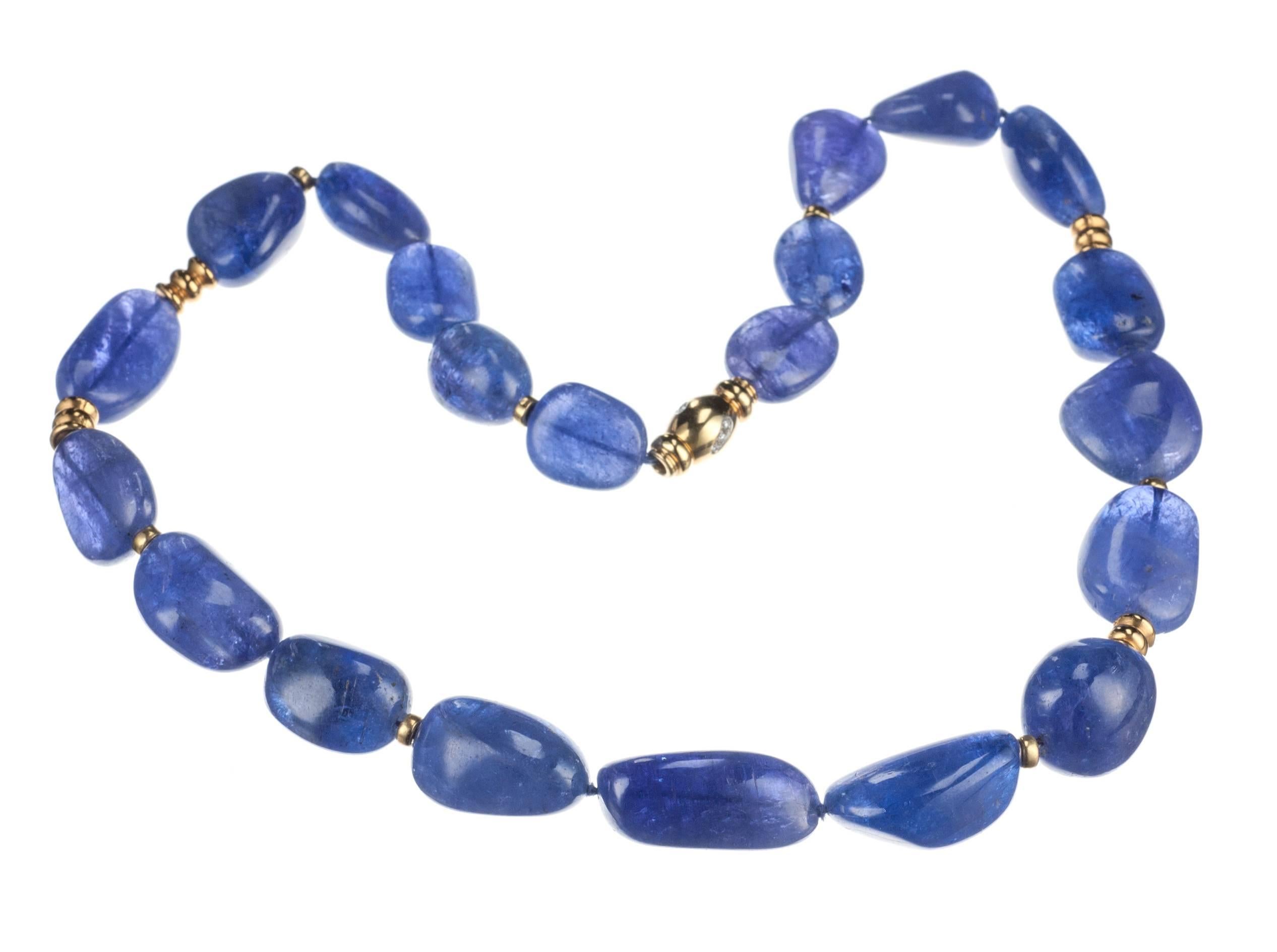 Vivid nuggets of blue-violet tanzanite are strung with 18-karat yellow gold beads and rondelles in this necklace from Elleard Heffern Fine Jewelers. The necklace is strung with an 18-karat yellow granulated clasp set with nine brilliant-cut round