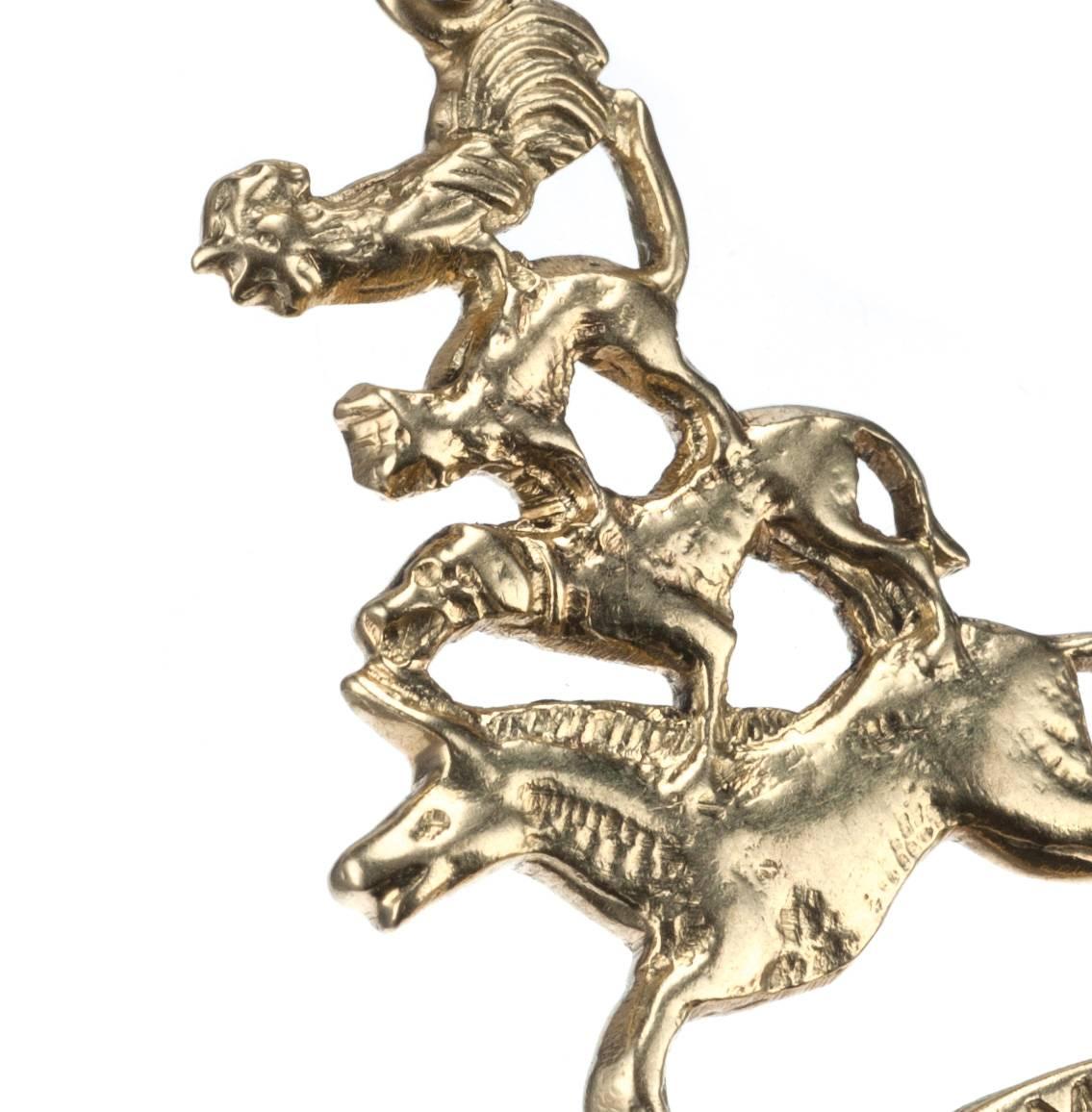 Based on the ‘Bremen Town Musicians’ fable, a 14-karat yellow gold charm featuring the titular characters: the donkey, dog, cat and rooster. Includes jump ring. Measures approx. 1.25” long. 