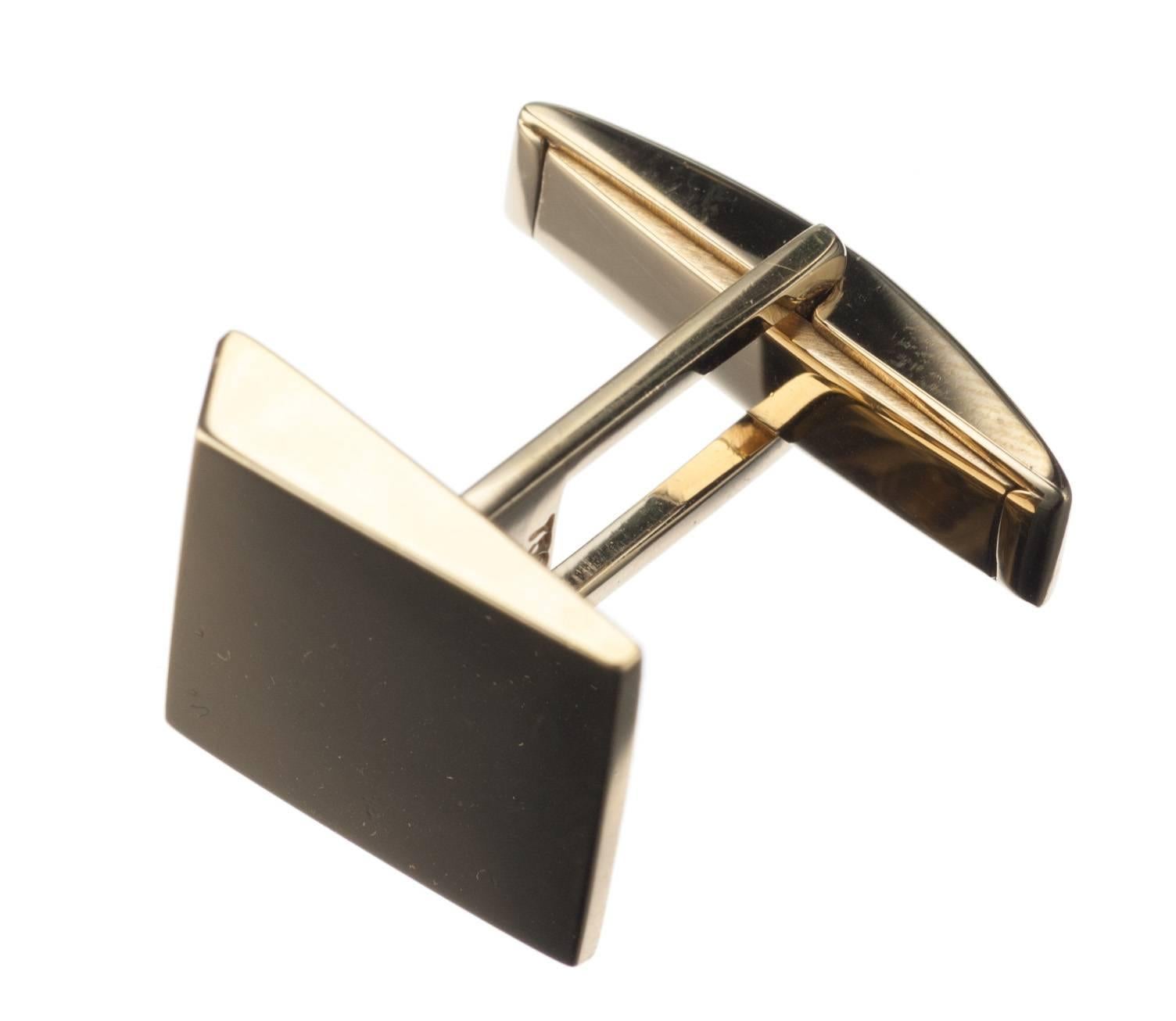 With glinting high polish 18-karat yellow gold certain to garner attention, a pair of wedge shaped cufflinks fastened with swivel backs. Measure approx. 0.5” square. 
