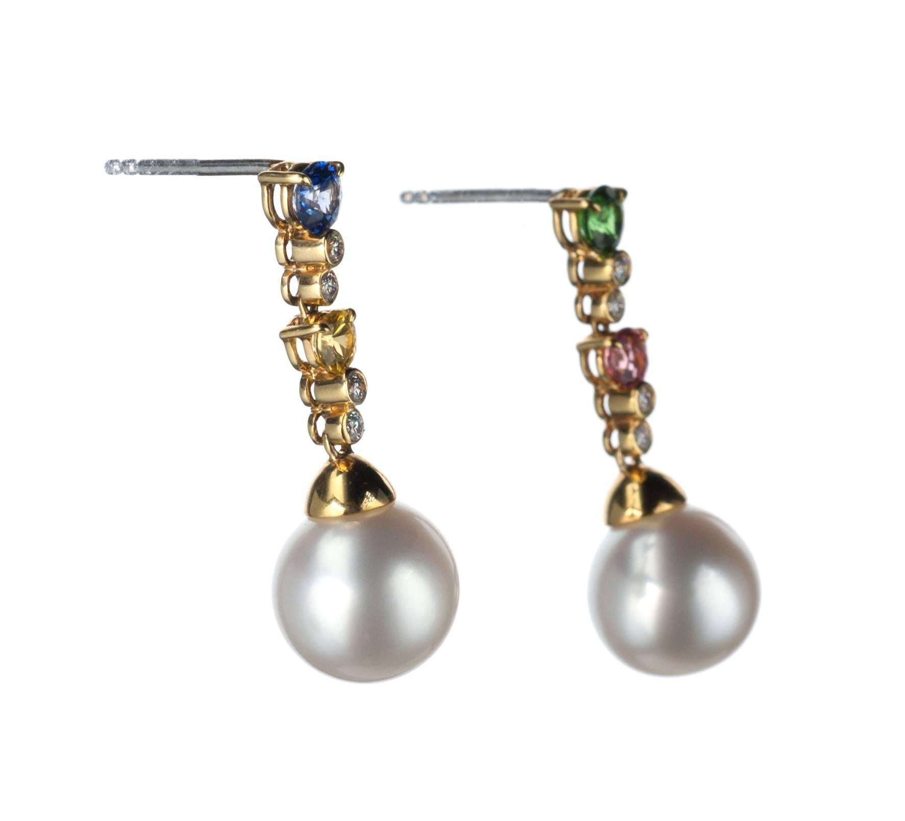 A playful pair of pearl drop earrings, from German designer Schoeffel, are set with a pair of south sea cultured pearls, approx. 10mm. Eight brilliant-cut round diamonds, .12ctw. of G color and VS clarity, are set in 18-karat yellow gold along with