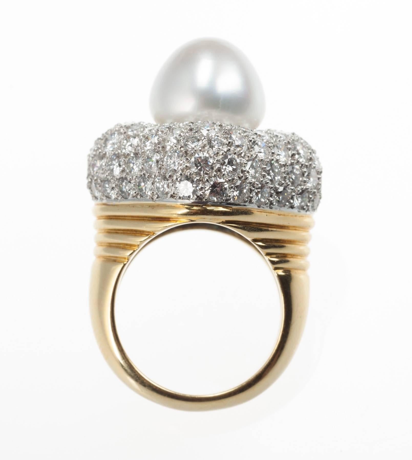 A single South Sea cultured pearl is set atop a pillow of platinum pavé-set with 110 diamonds, 5.90ctw. of G-H color and VS clarity, in this 18-karat yellow gold ring. Pearl measures 12mm in diameter. Size 6.5; can be sized. Top of ring measures