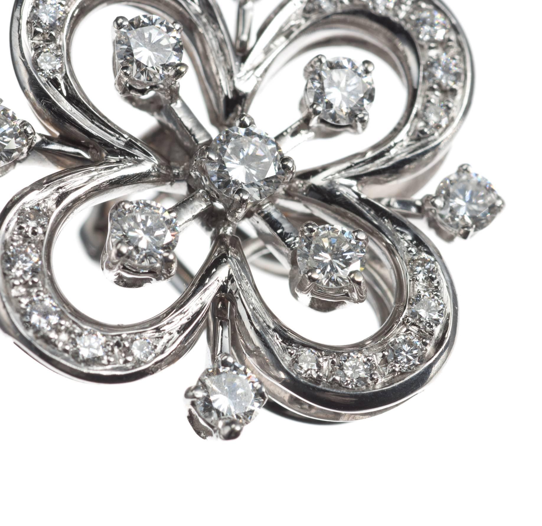 A pair of quatrefoil floral earrings, from Italian design Barzizza is fashioned in 18-karat white gold and set with 58 round brilliant-cut diamonds, 1.78ctw. of G-H color and VVS1-VVS2 clarity. Secured with omega clip backs. These earrings offer a