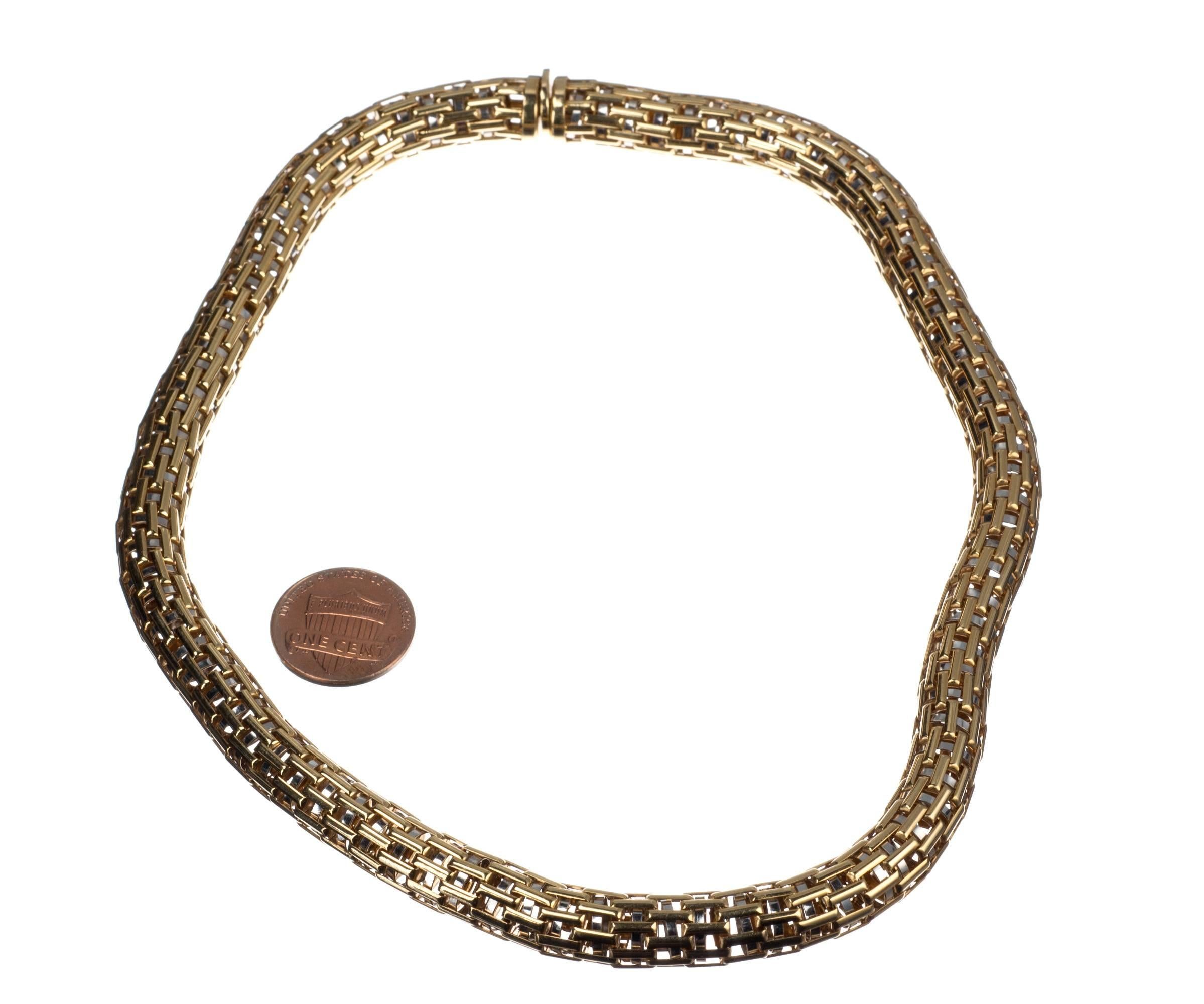 An intricate marvel of craftsmanship from Italian designer VAID, this 18-karat yellow gold choker’s smooth, woven exterior belies its complexity. Free-floating 18-karat white gold rings nestled into each woven segment add a subtle shimmer and soft