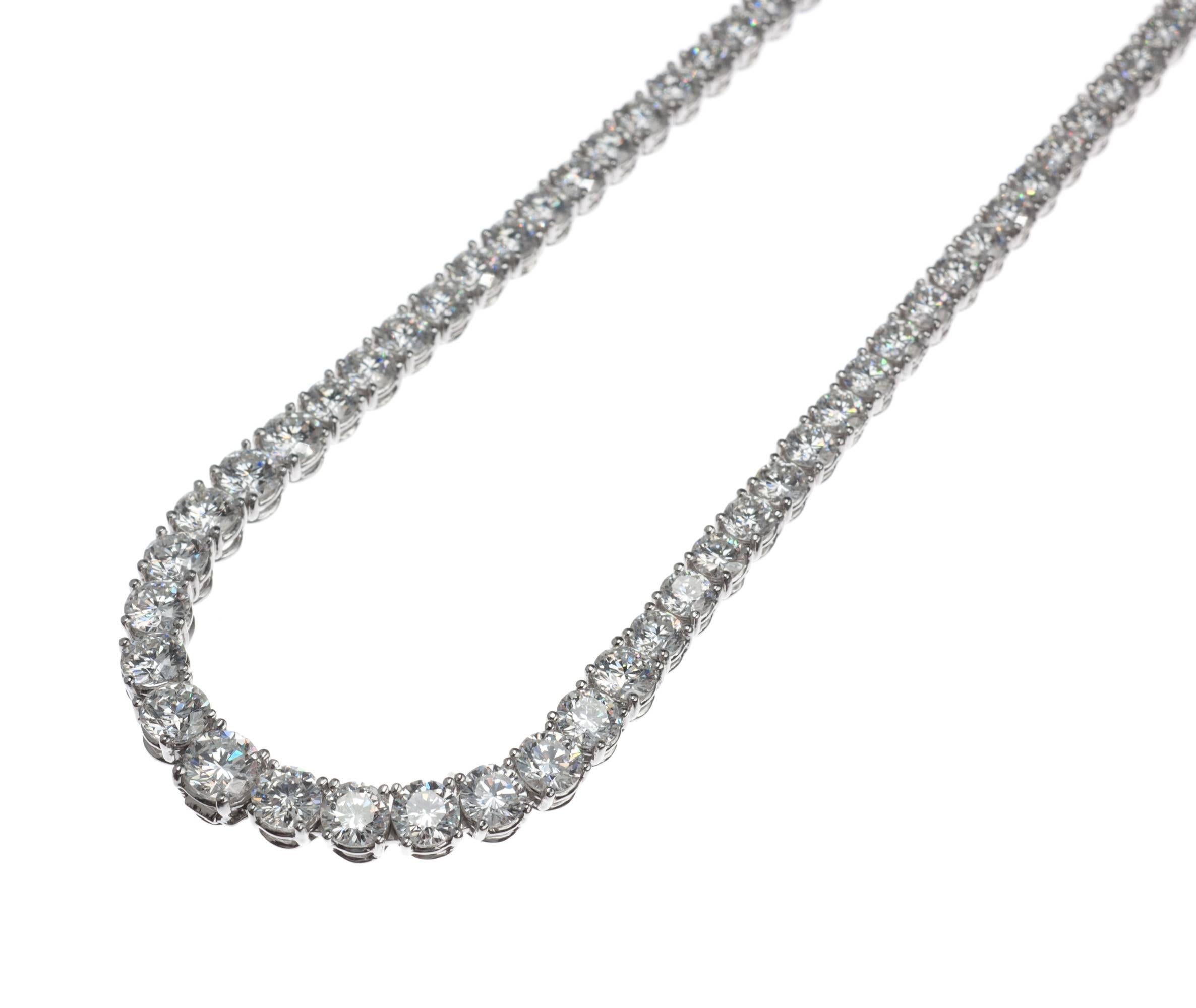 An elegant platinum riviera necklace set with 139 brilliant-cut round diamonds, approx. 11.98ctw. of G-H color and SI1-SI2 clarity, tapering from approx. .05ct. diamonds near the clasp to an approx. .32ct. diamond at center. Discretely hidden away
