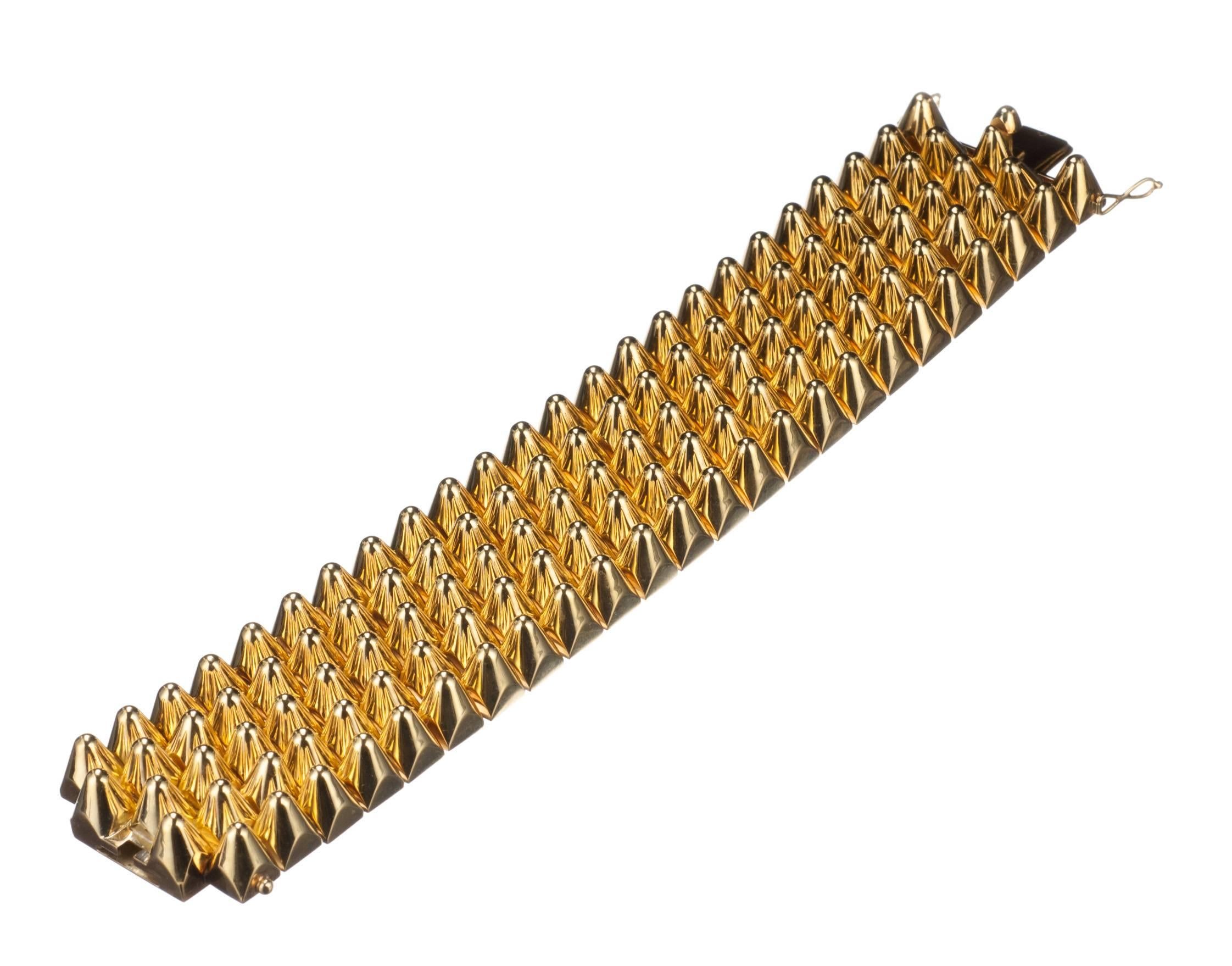 Solid, classic, and just a little bit edgy, this studded 18-karat yellow gold bracelet can’t help but make a bold statement. Each golden spike is linked together into a flexible, form fitting work of superb craftsmanship. Measures 1.5” wide and