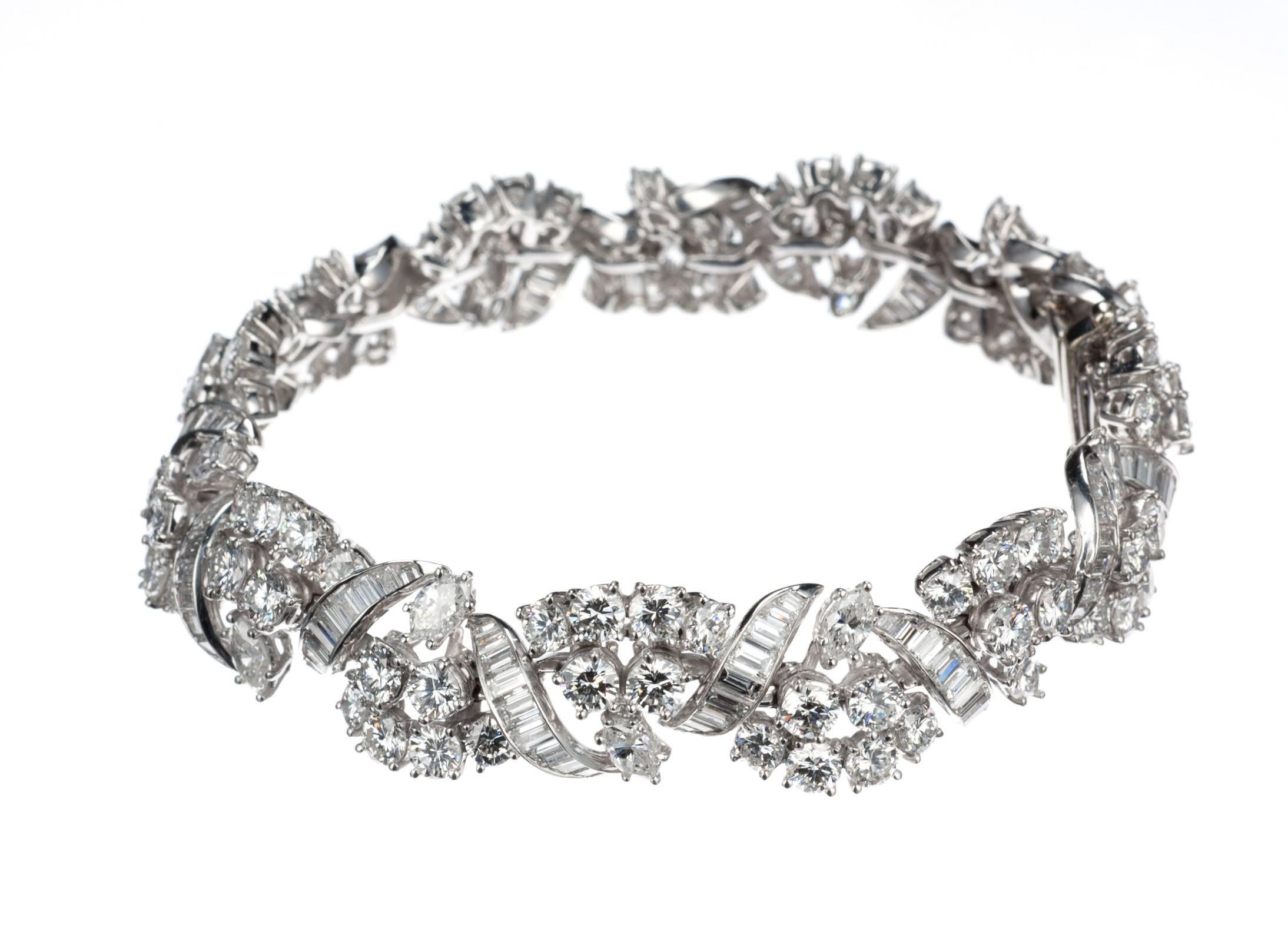 A platinum diamond bracelet fashioned in subtle natural motifs like a charming garland of leaves. Set with a dazzling array of diamonds including 88 brilliant-cut round diamonds, 11.16ctw., 135 baguette-shaped diamonds, 5.37ctw., and 14