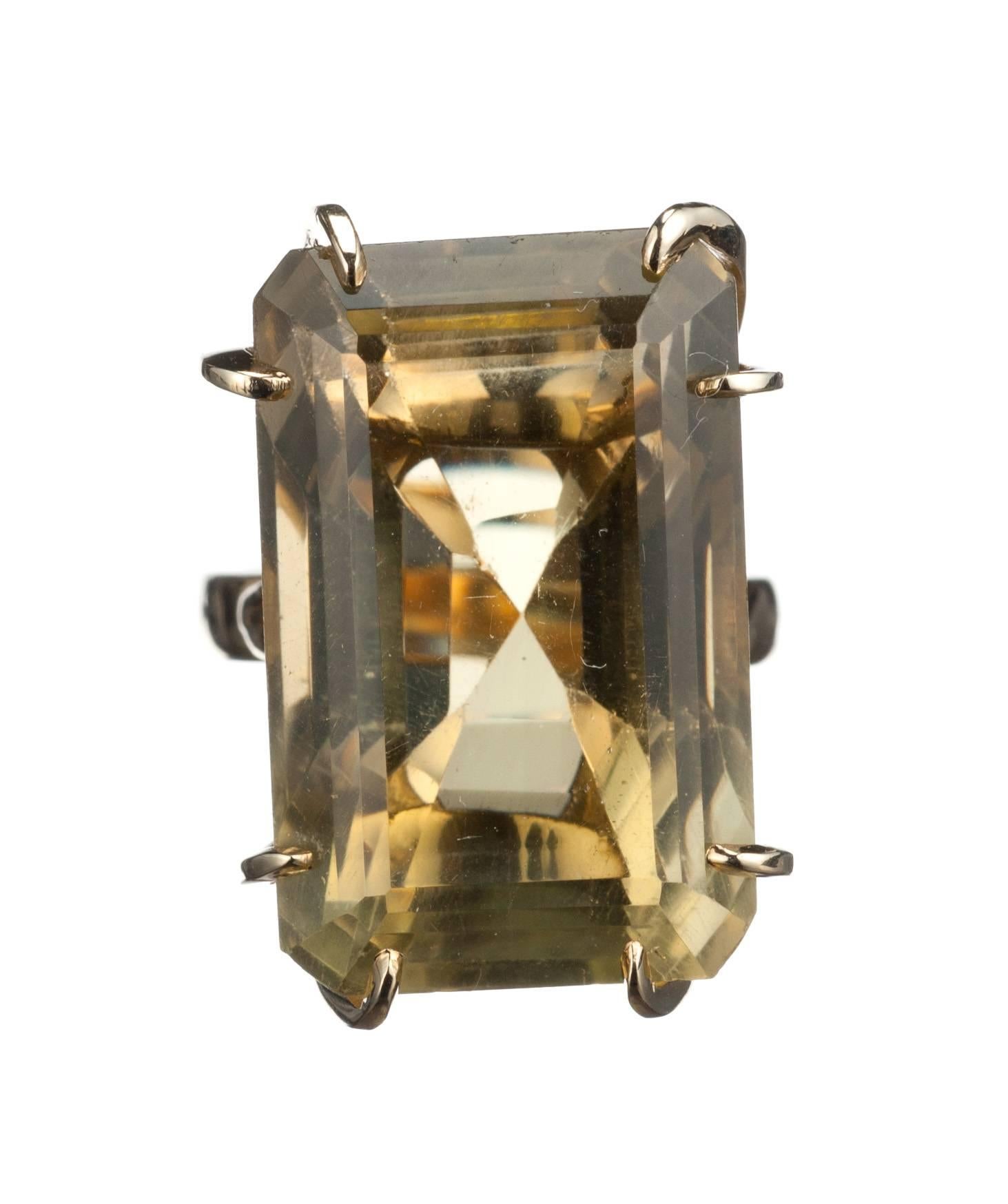 A bold cocktail ring composed of 14-karat yellow gold and set with a remarkable emerald-cut citrine, approx. 40.43ct. Fits a size 7 finger with an additional spring guard to accommodate larger knuckles. Citrine measures approx. 1” long by 0.5” wide. 