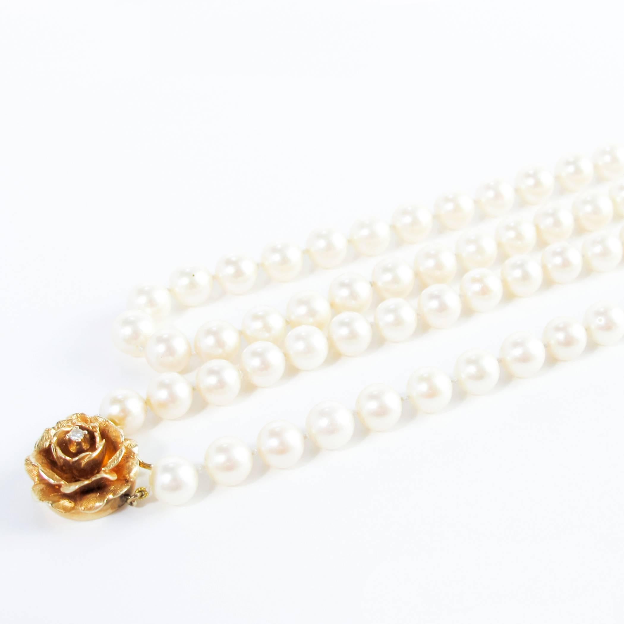 Opera Length Pearls with Gold and Diamond Flower Clasp In Excellent Condition For Sale In Toronto, Ontario