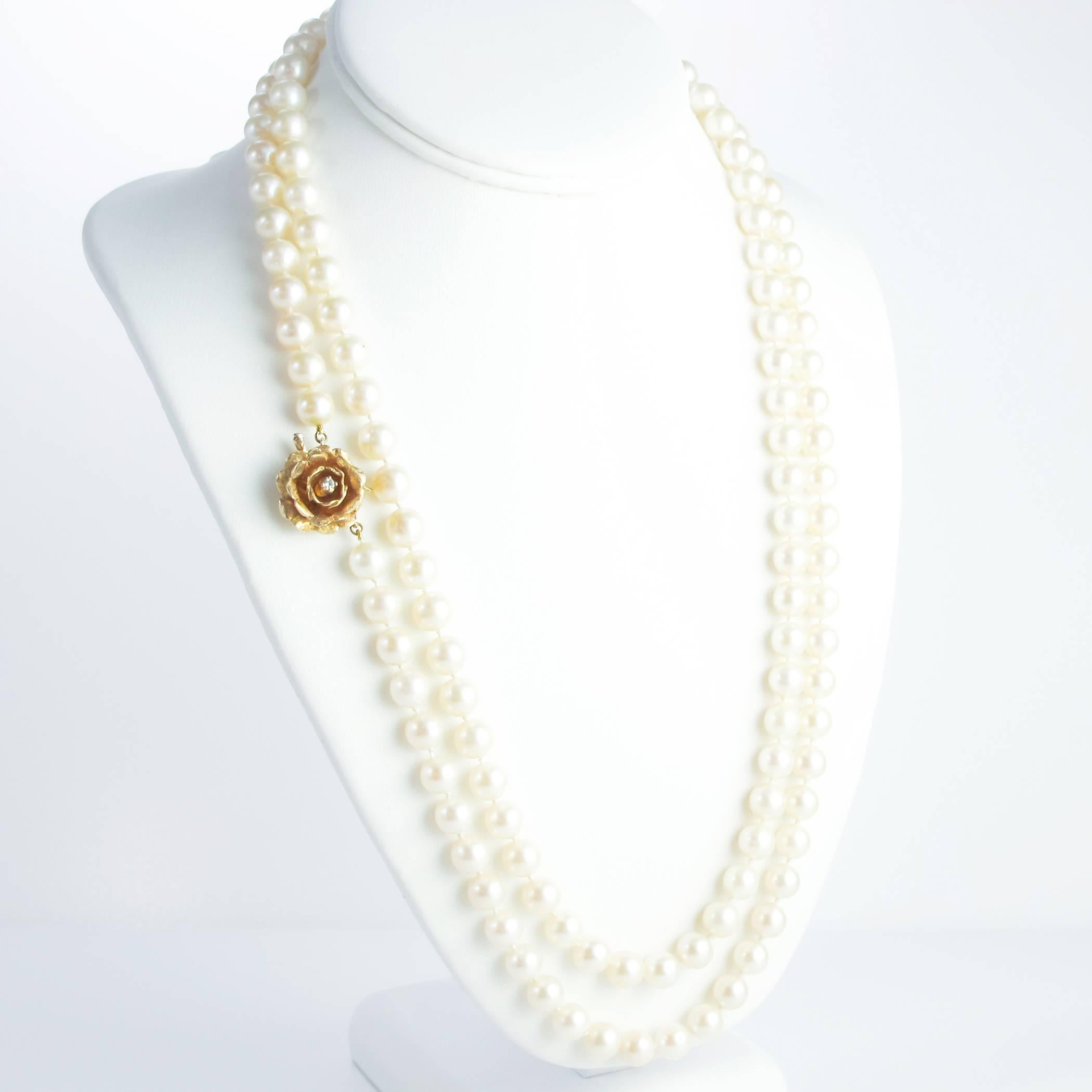 A mid century strand of 8 - 8.5mm saltwater cultured pearls measuring 51 inches long. The pearls are silver cream with slight rose, green and aubergine overtones. 

A beautiful 14K gold hand crafted clasp comes in the form of a ruffled rose and is