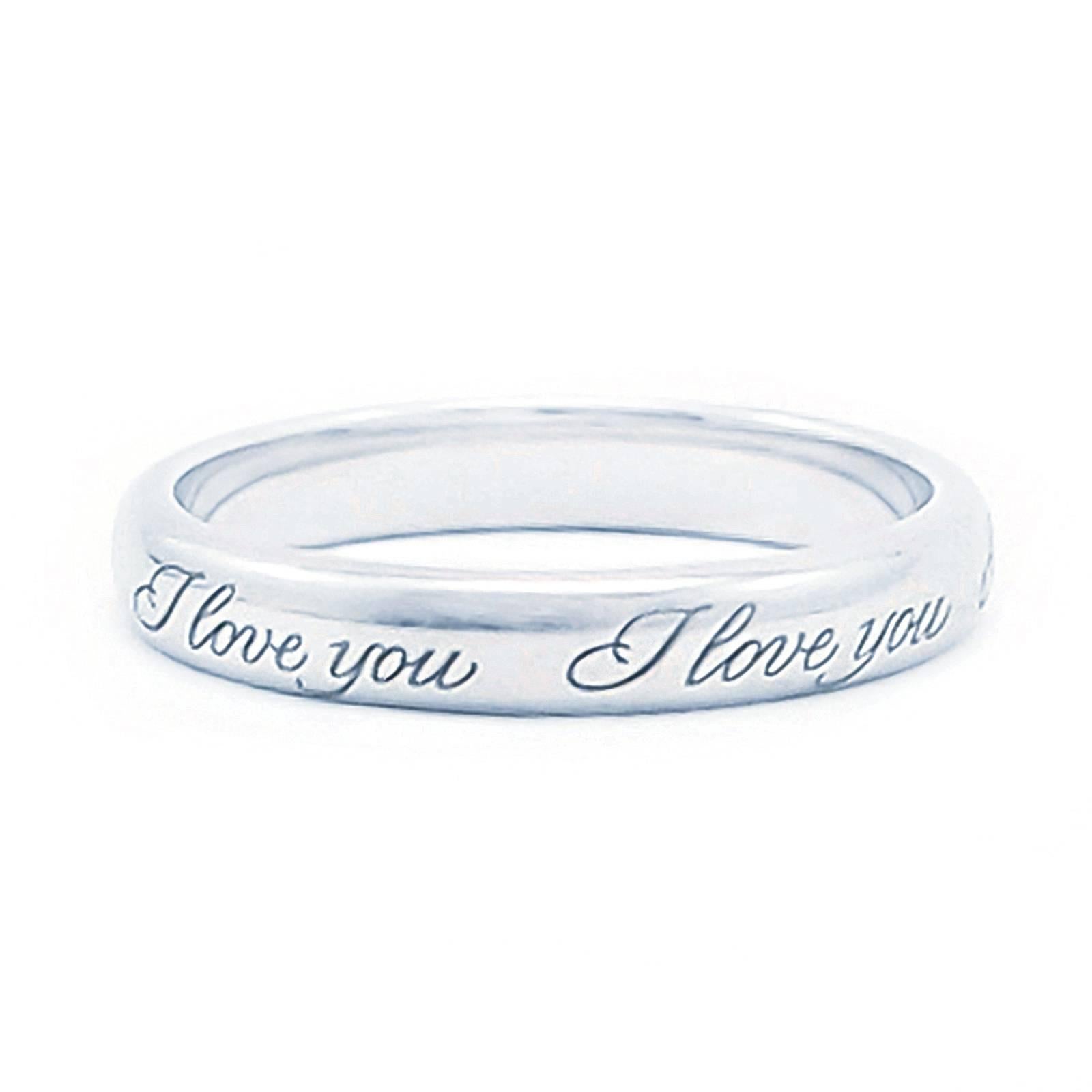 This 3mm Platinum band from the Tiffany Notes collection is softly domed and engraved with the script I Love You repeated around the outside of the ring.  Size 6.

Simple, elegant and understated.

CONDITION: In overall excellent condition with
