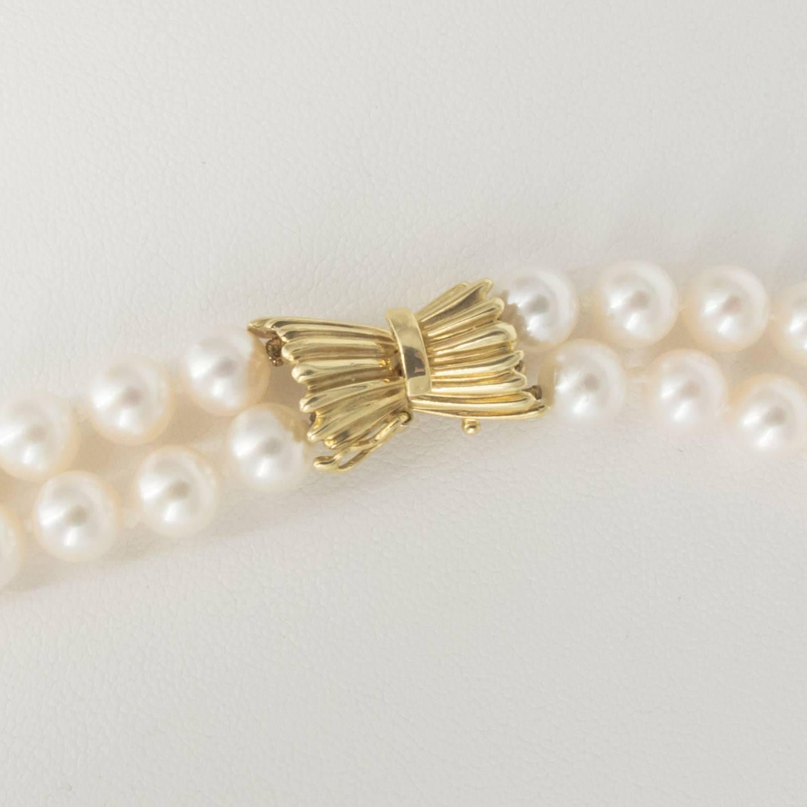 A fine double strand of AA quality Japanese Akoya Cultured Pearls measures 16 and 17 inches respectively, caught with a beautiful, bow shaped 14 Karat Gold clasp.

There are 106, well rounded and matched 7.00-7.50mm Pearls in this classic and
