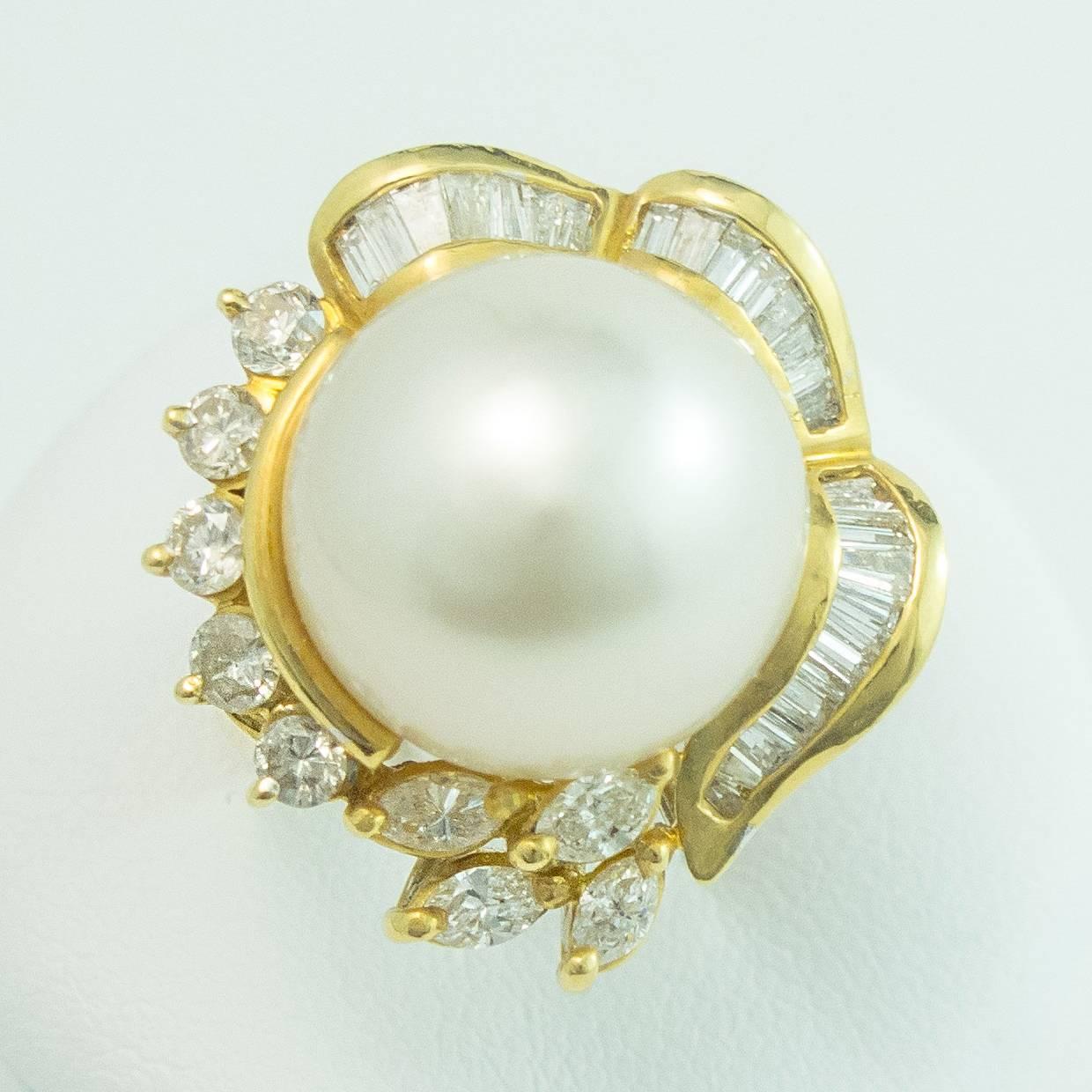 A gorgeous South Sea White Pearl and Diamond 18 Karat Yellow Gold Ring. This fine 14mm South Sea Pearl is round, white with aubergine and cream undertones and center set in a stunning hand crafted 18K yellow gold mount. 

The Pearl is surrounded