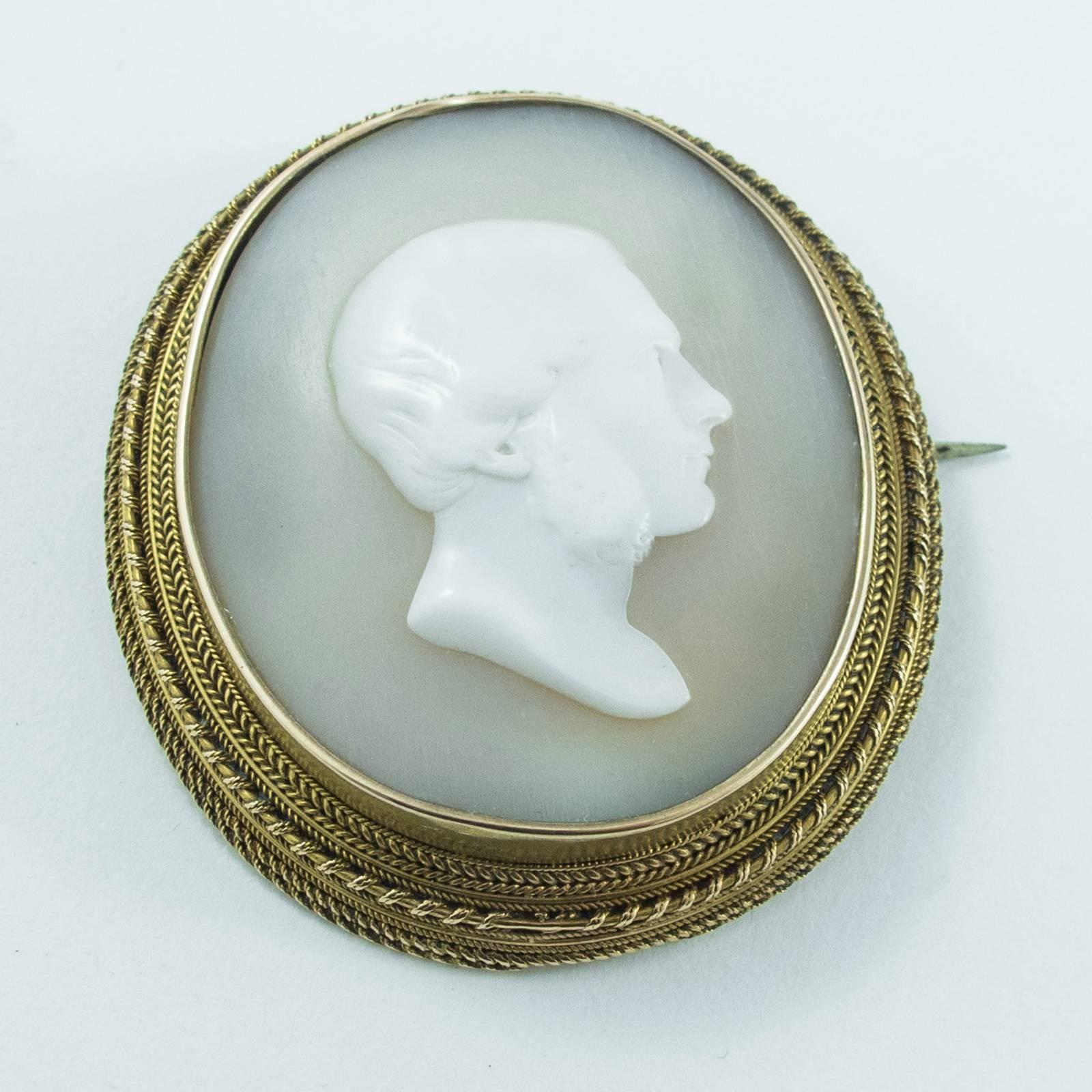 A simple and beautifully rendered cameo portrays a male in profile mounted in a hand crafted elegant 18K red gold frame.

The shell itself is unusual in that the ground is semi translucent and appears as a soft dove grey - a gorgeous juxtaposition