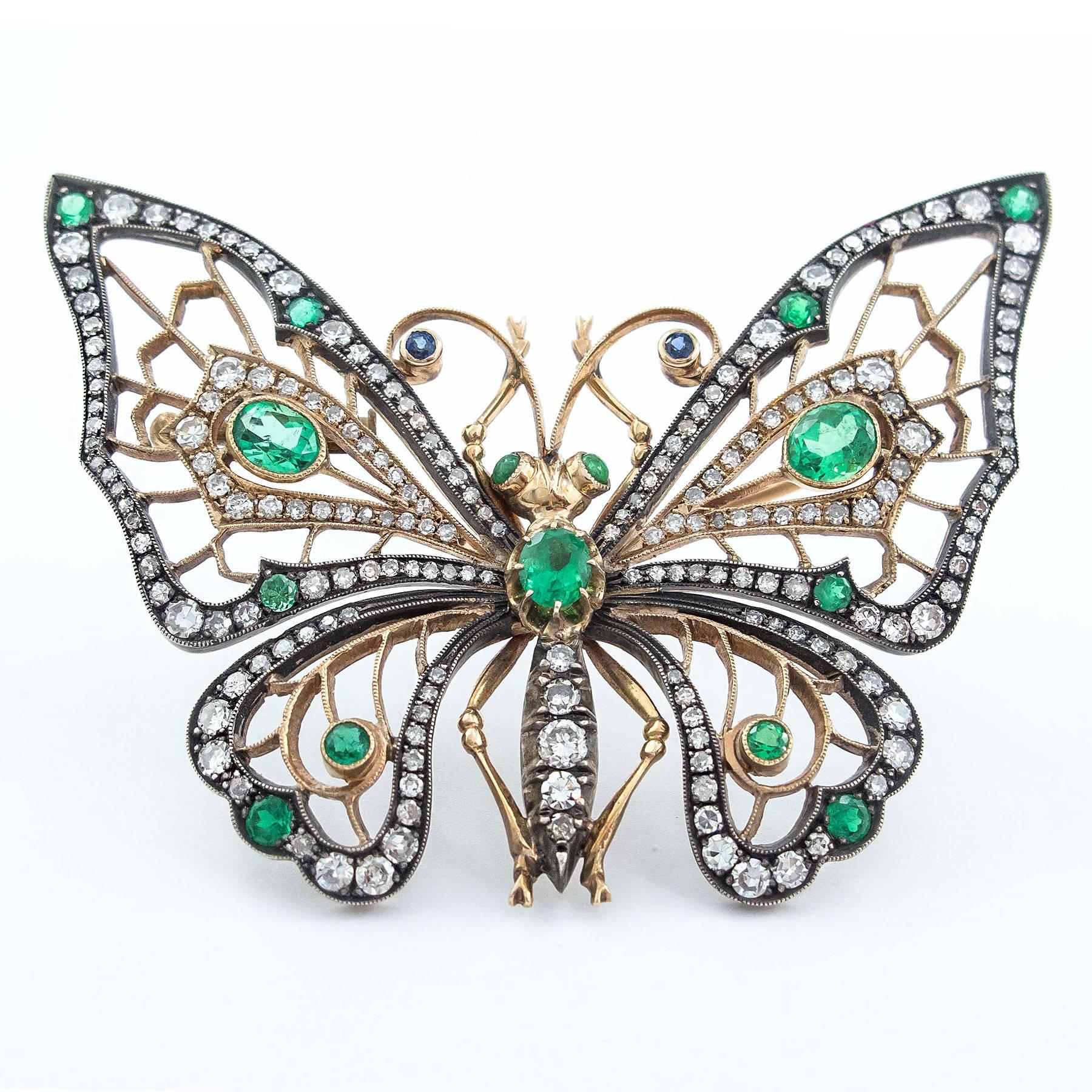 A gorgeous Emerald Diamond Butterfly Brooch is set with 206 Emeralds and Diamonds totaling 4.25 carats. It is further detailed with 2 small Blue Sapphire cabochon eyes and set in a hand crafted 14 Karat gold and silver mount.

The butterfly is a
