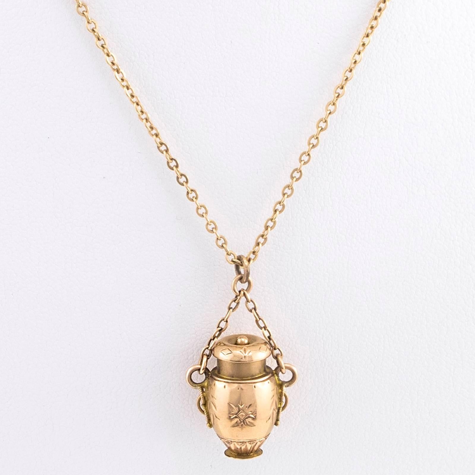 A rare 15 Karat Gold Victorian Lidded Amphora is suspended from its original short chain that hangs from the well matched 16 inch long neck chain.

The lid on the Amphora is removable (as shown in the photographs) and the short chain attached to the