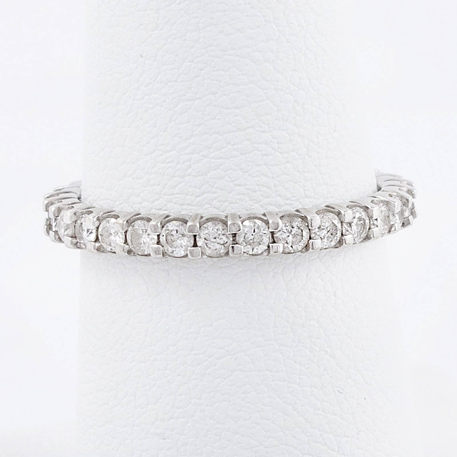 An elegant Eternity/Stacker band is set with 30 round, brilliant cut Diamonds totaling approximately .60 carats, set in 14K white gold .

The ring was custom crafted, with Diamonds set in the shared claw fashion. Currently a size 6.5, it should not