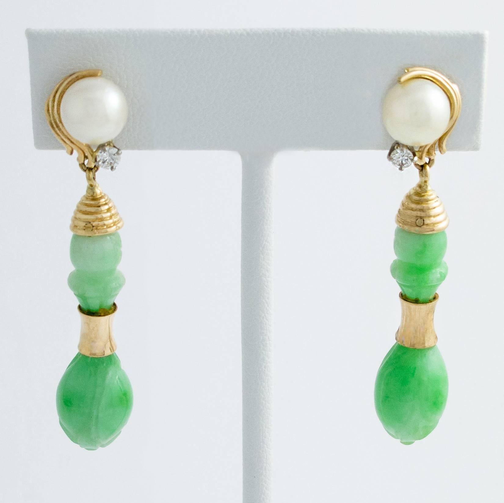 Pretty carved Jade drops are suspended below 6mm Salt Water Cultured Pearls, detailed with a single Diamond, in these pretty 14K yellow gold earrings.

The earrings measure 1.75 inches from top to bottom with the Jade drops alone being 1.25 inches