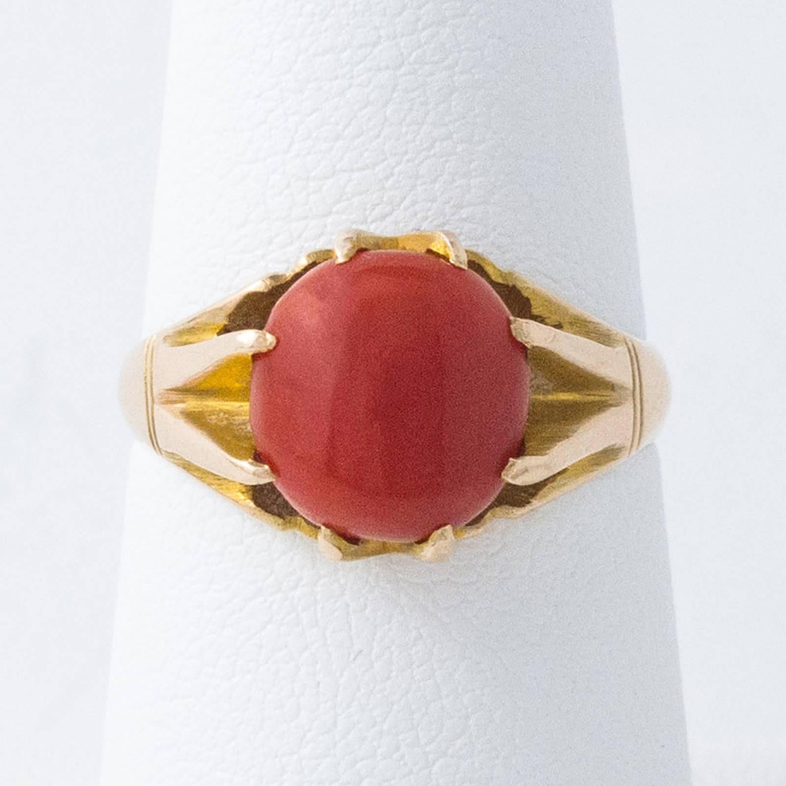 A cabochon cut Red Coral stone is set within 8 decorative claws in this pretty dome style, 14 karat gold tomato-red coral ring.

The top of the ring measures 10mm north to south and rises 6mm up off the top of the finger.  Currently a size 6.5, we