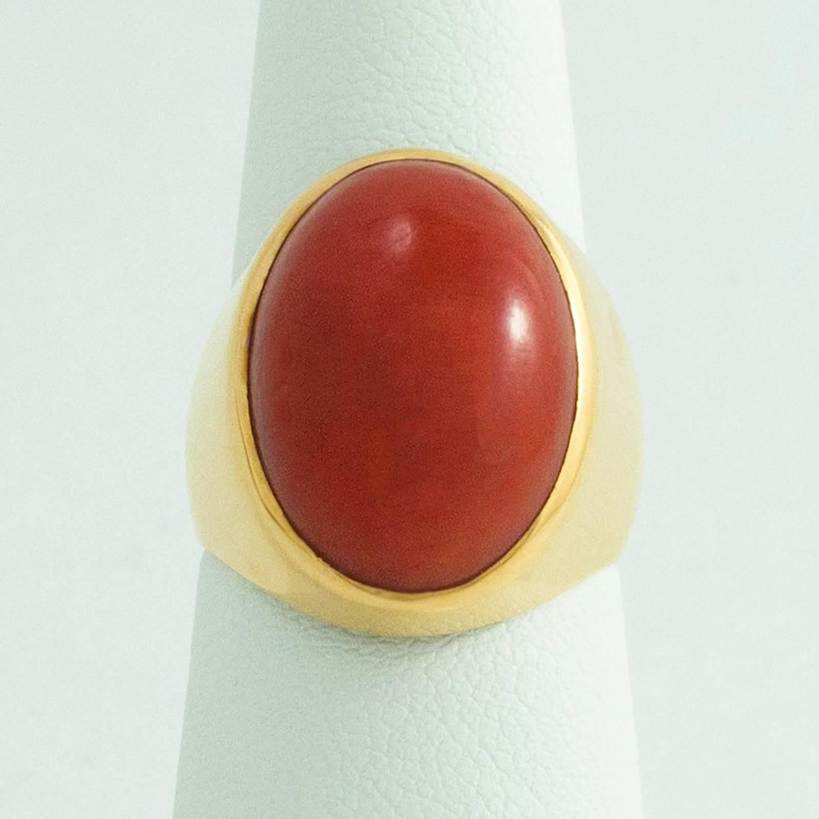 A fine Sardinian Red Coral ring crafted in 18 Karat yellow gold is simple, impressive and absolutely stunning!

The Coral is cabochon cut and measures 18.00mm north to south on the finger x 12.70mm across and 6.10mm high. It is becoming more and