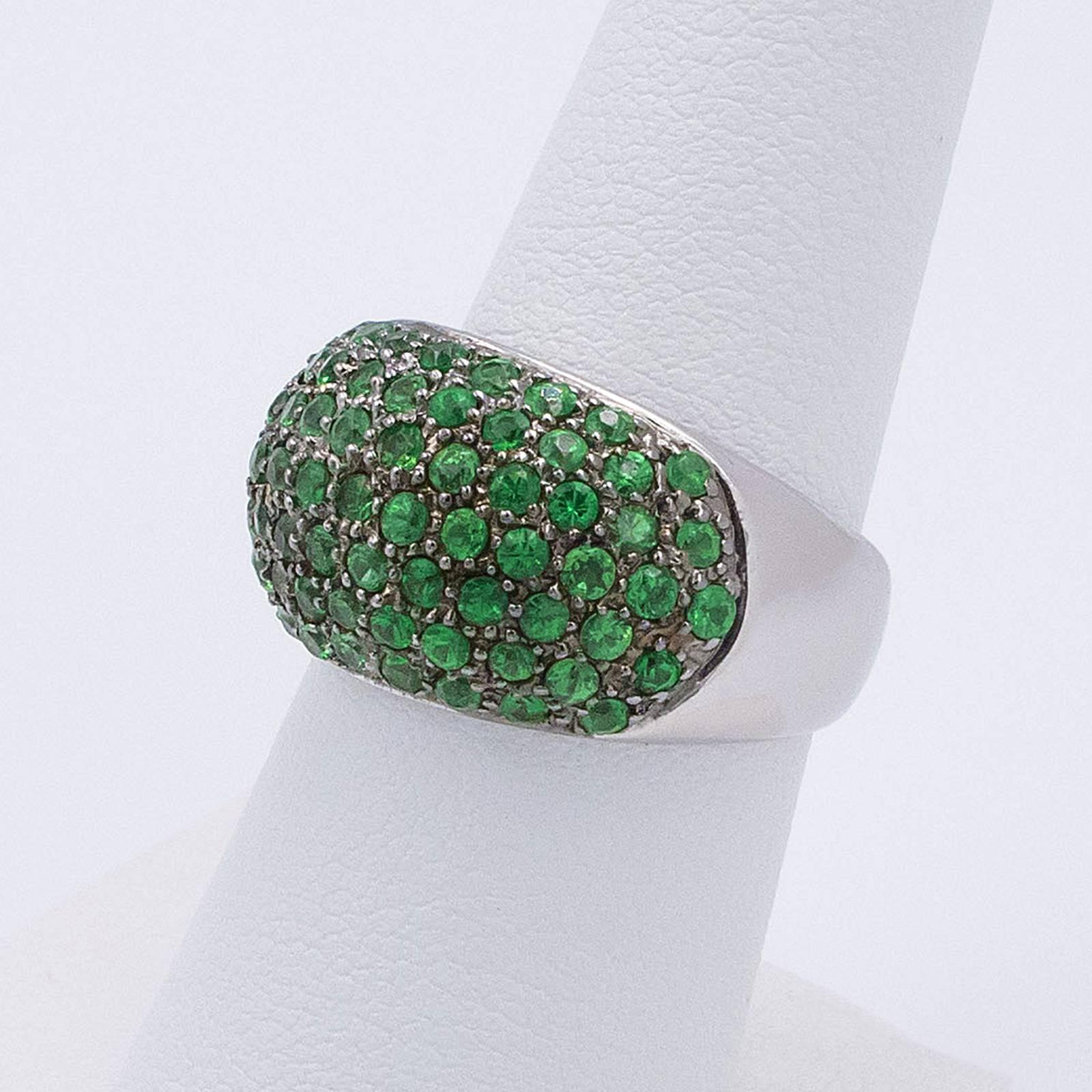 A stunning white gold band is pave set with 73 round Tsavorite Green Garnets to the domed top of the ring.

The band is 3/4 inch wide at the top and rises up 3/16 inch off the finger. Currently a size 6.5 we can custom size this up or down to suit