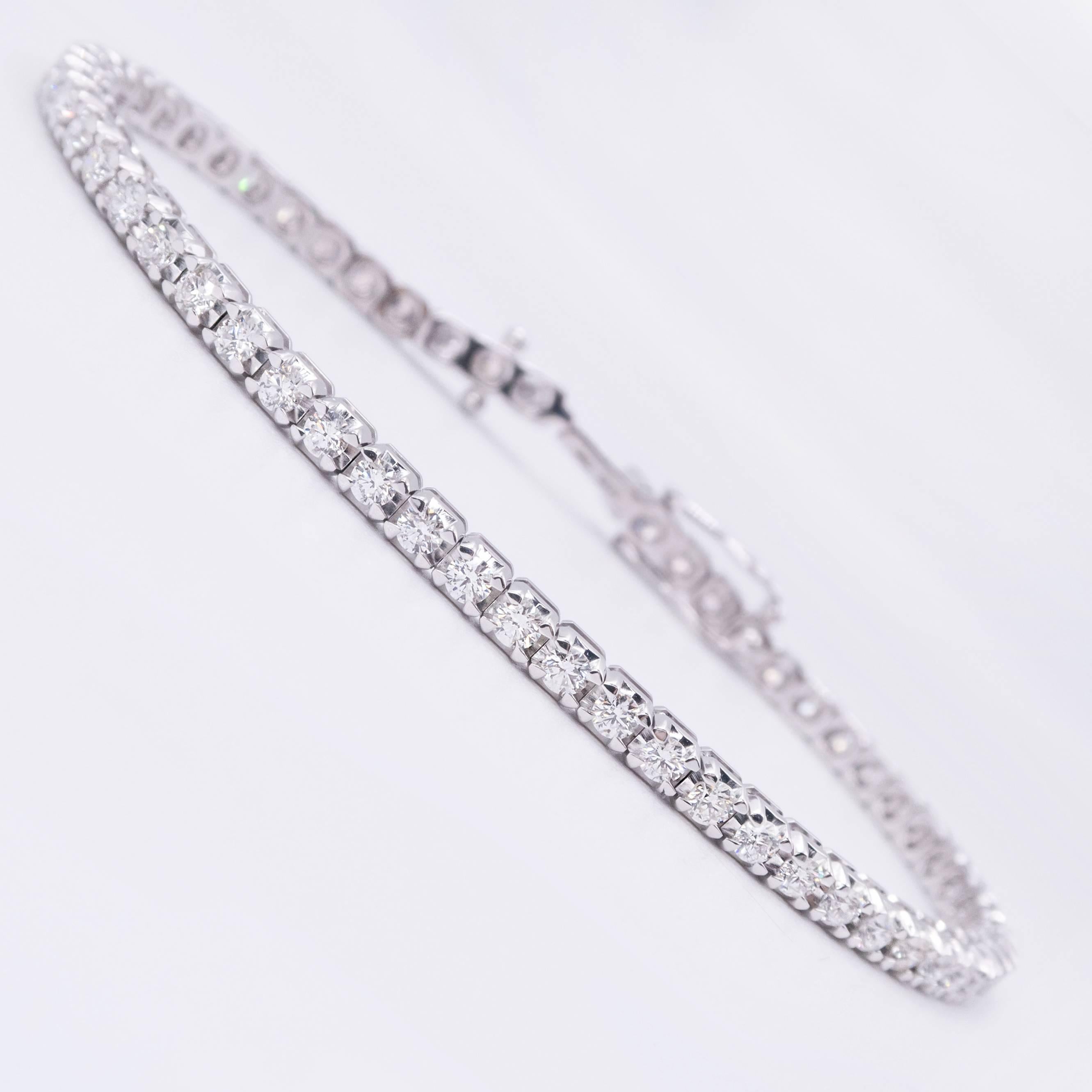 This classic 18 Karat White Gold Diamond Tennis Bracelet is set with 51 round, Brilliant Cut VS12, E-F-G Diamonds totaling 3.62 carats by gauge and formula.

Each Diamond is set with 4 tiny prongs inside the larger Illusion Setting, giving the