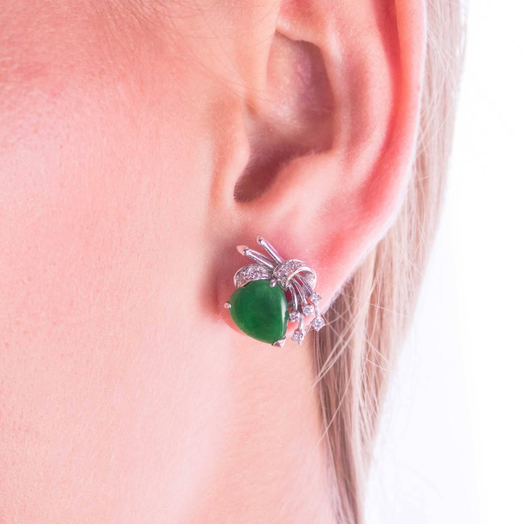 A pretty pair of Jadeite earrings are embellished with 18 single cut Diamonds and set in 18 Karat White Gold custom crafted mounts.

The earrings have Omega post clip retainers to keep them sitting well on the ears.

CONDITION:  In overall excellent