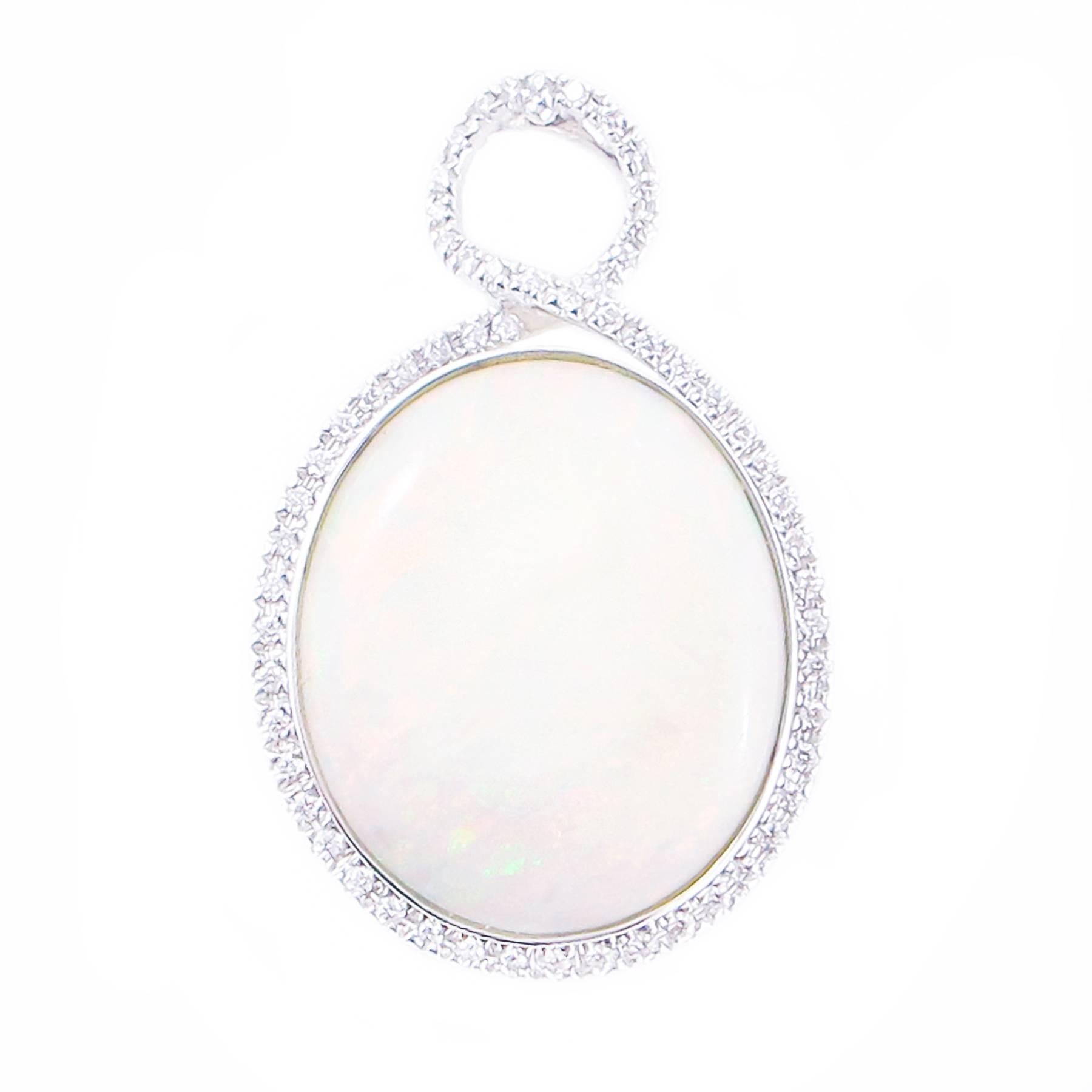 A large, impressive Australian Opal and Diamond Pendant set in 18K Gold.

This lovely pendant is set in a hand crafted 18K white gold mount and inset with 68 round, Brilliant Cut Diamonds.

Condition: Opal: white with rolling flashes of red, yellow,