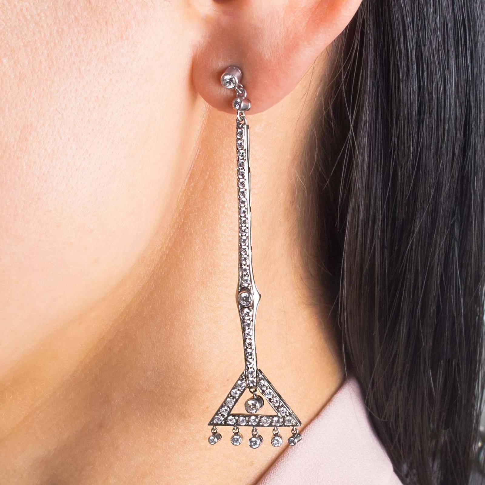 A gorgeous pair of hand crafted Art Deco earrings set in Platinum, with 114 Diamonds totalling 1.95 carats. 

The Diamonds are bead and bezel set with refined millegrain detailing. Safety spring disc Platinum backs on posts. Elegant and cleverly