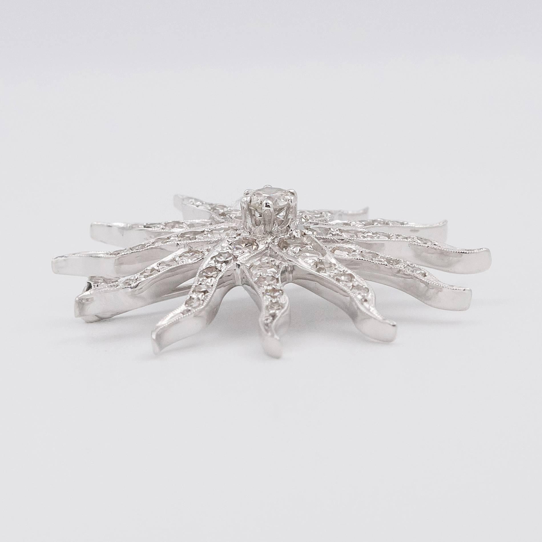 A dazzling Belle Epoque Diamond set Sunburst Brooch. This white over Yellow Gold Sunburst is set with 55 Diamonds graduating in size from 1.25mm to 3.45mm totalling 1.10 carat by gauge and formula. The brooch is 14K white gold with good dimension