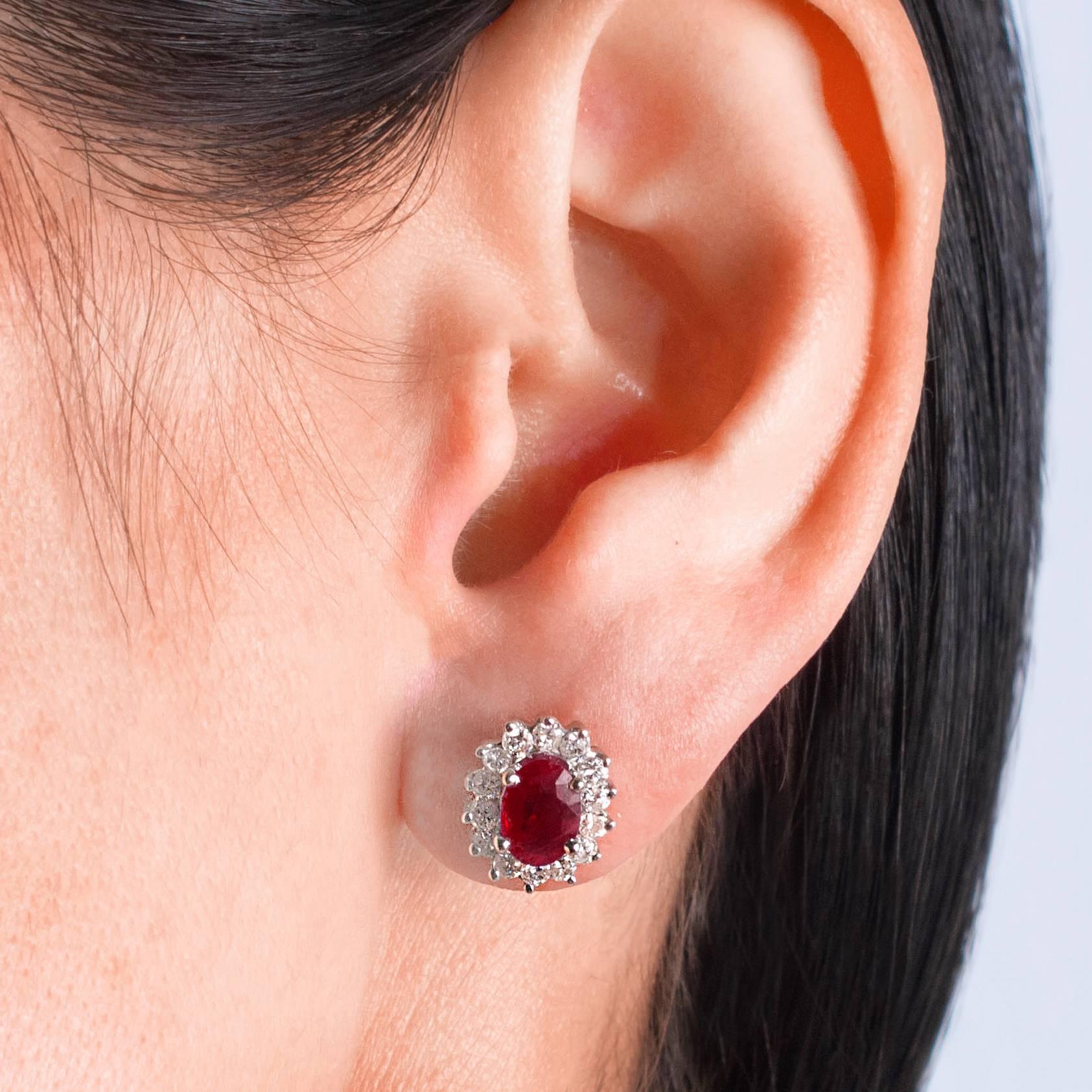 These Ruby and Diamond earrings are timeless. The oval cut Rubies are set in the Princess form surrounded with Diamonds. Gorgeous on the ears!

The Rubies are red, oval cut and faceted and surrounded with beautiful round,  Brilliant cut Diamonds set